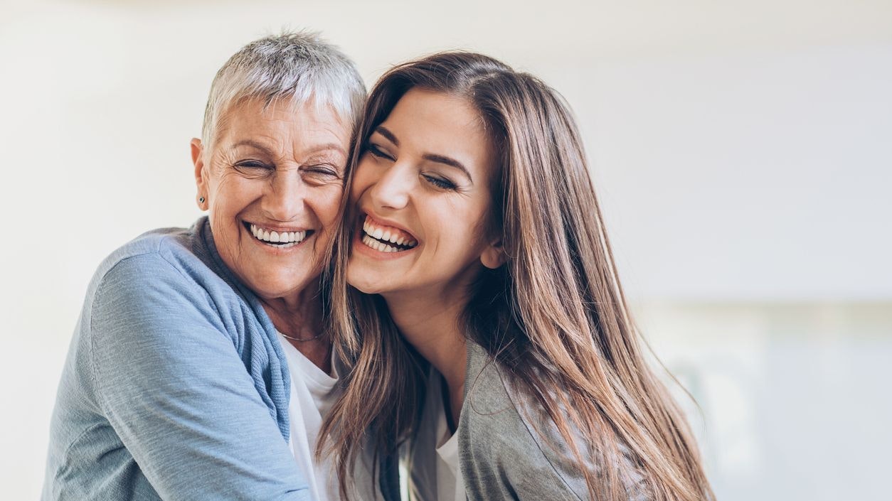 Senior and young women embracing at home