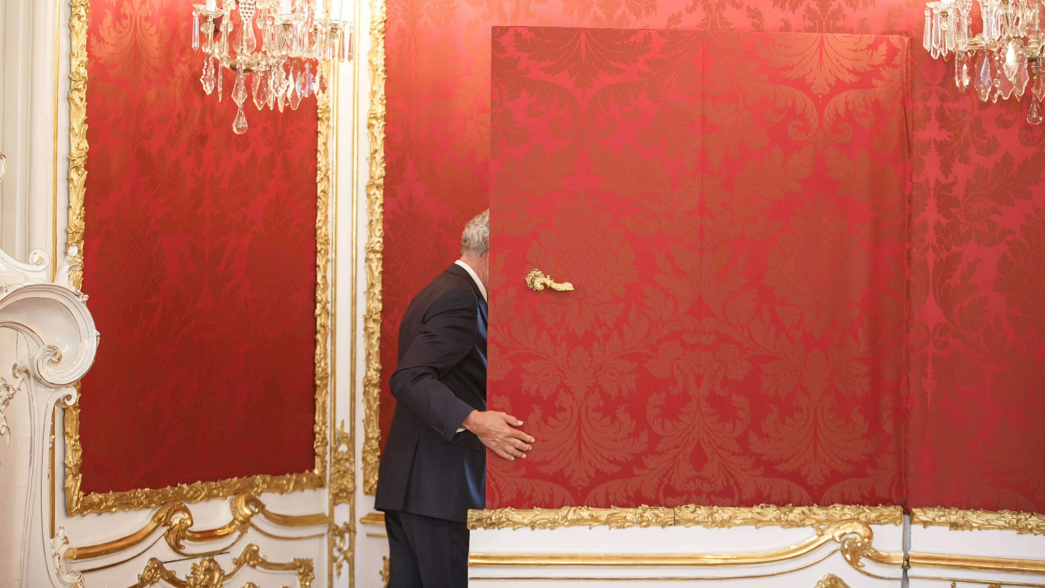 Bundespräsident Alexander Van der Bellen verschwindet in der Präsidentschaftskanzlei in der Hofburg  durch die Tapetentüre