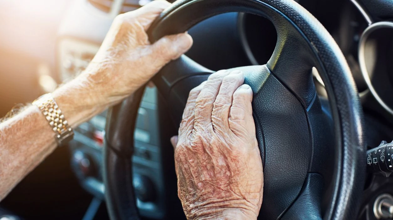 Closeup of an unrecognizable senior man's hands on the steering wheel of his car