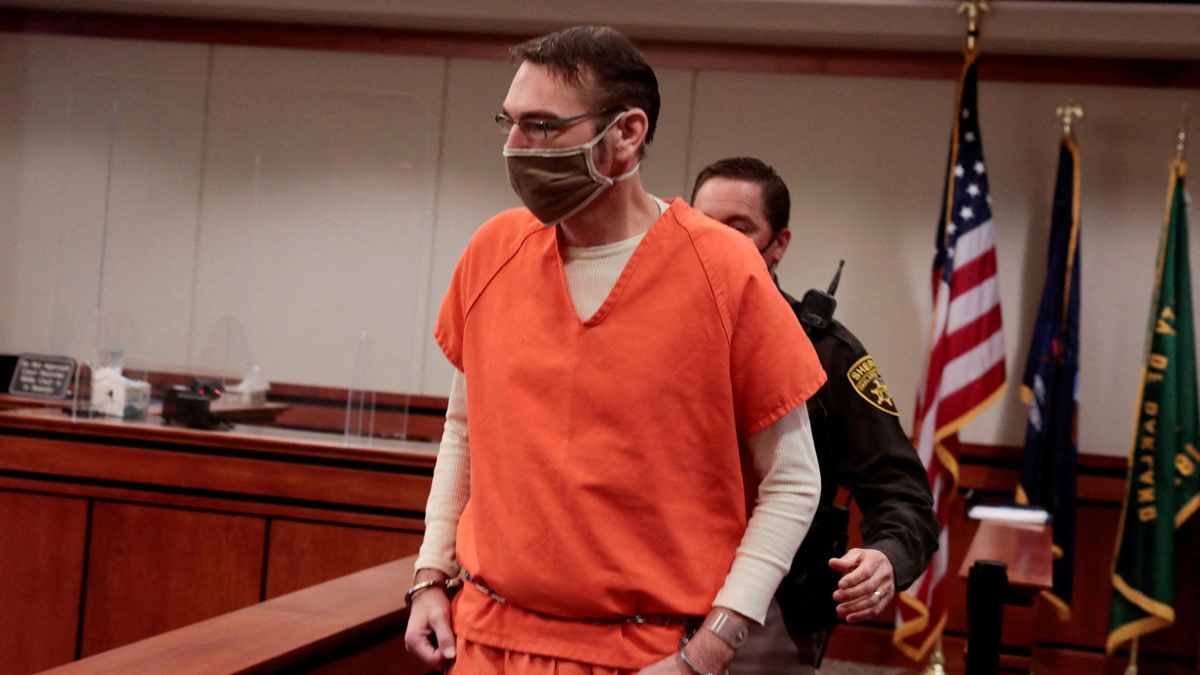FILE PHOTO: James Crumbley, parent of accused Oxford High School gunman Ethan Crumbley, is escorted into the courtroom by a Oakland Count Sheriff during a court procedural hearing in Rochester Hills, Michigan, U.S., February 24, 2022. REUTERS/Rebecca Cook/File Photo