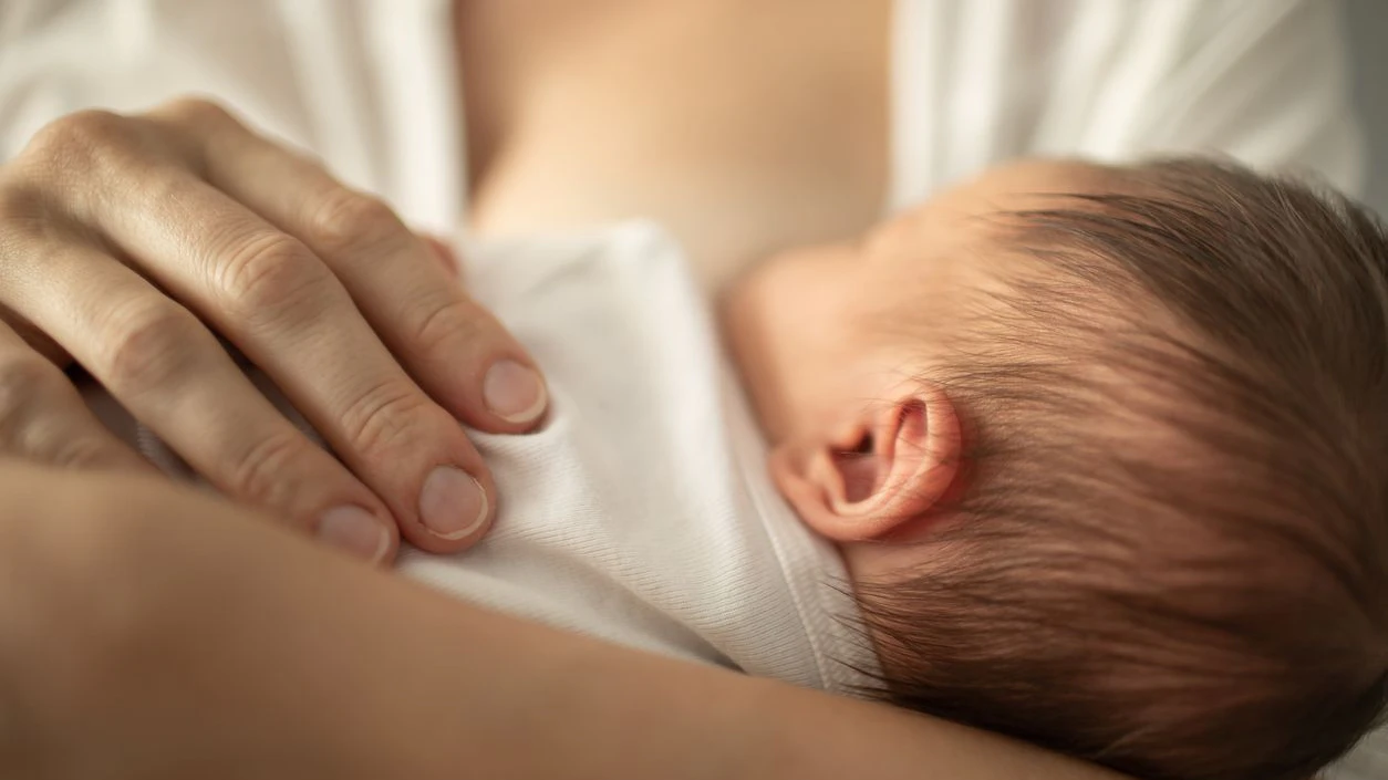 Mother breastfeeding her little baby girl. Breastfeeding and family concept.