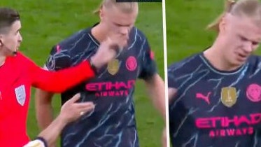 Erling Haaland bekommt die Hand vom Champions-League-Referee ins Gesicht.