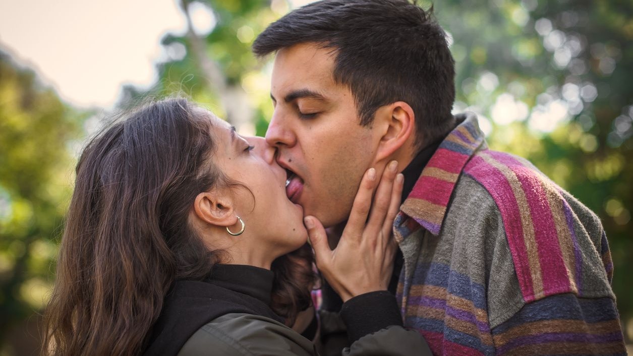 Close-up detail view of sexy French deep kiss. Sensual romantic couple in love hugging and kissing. Girl and boyfriend dating. Relationship and romance concept