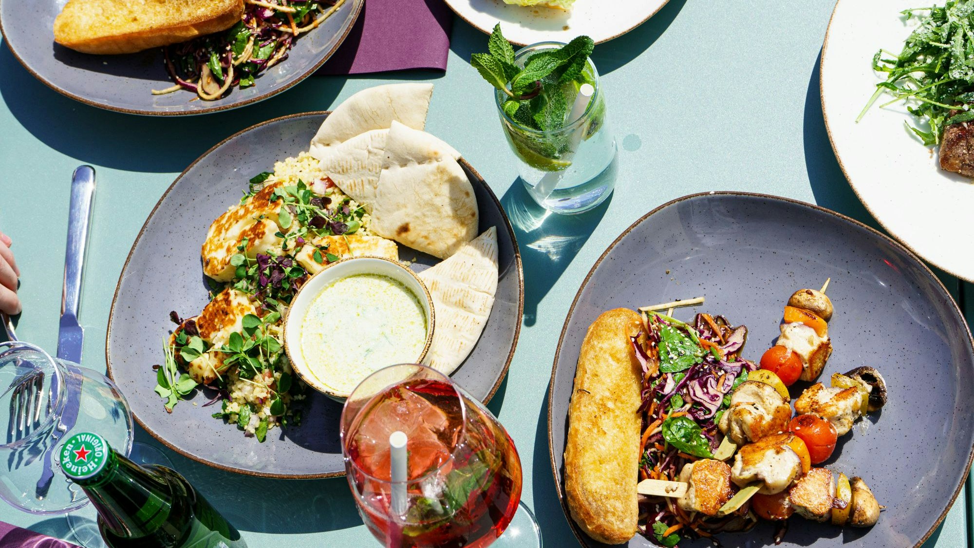 Orientalisch wird der Hühnerspieß mit Tabouleh, Tahina Dip und Pita serviert oder klassisch am Spieß