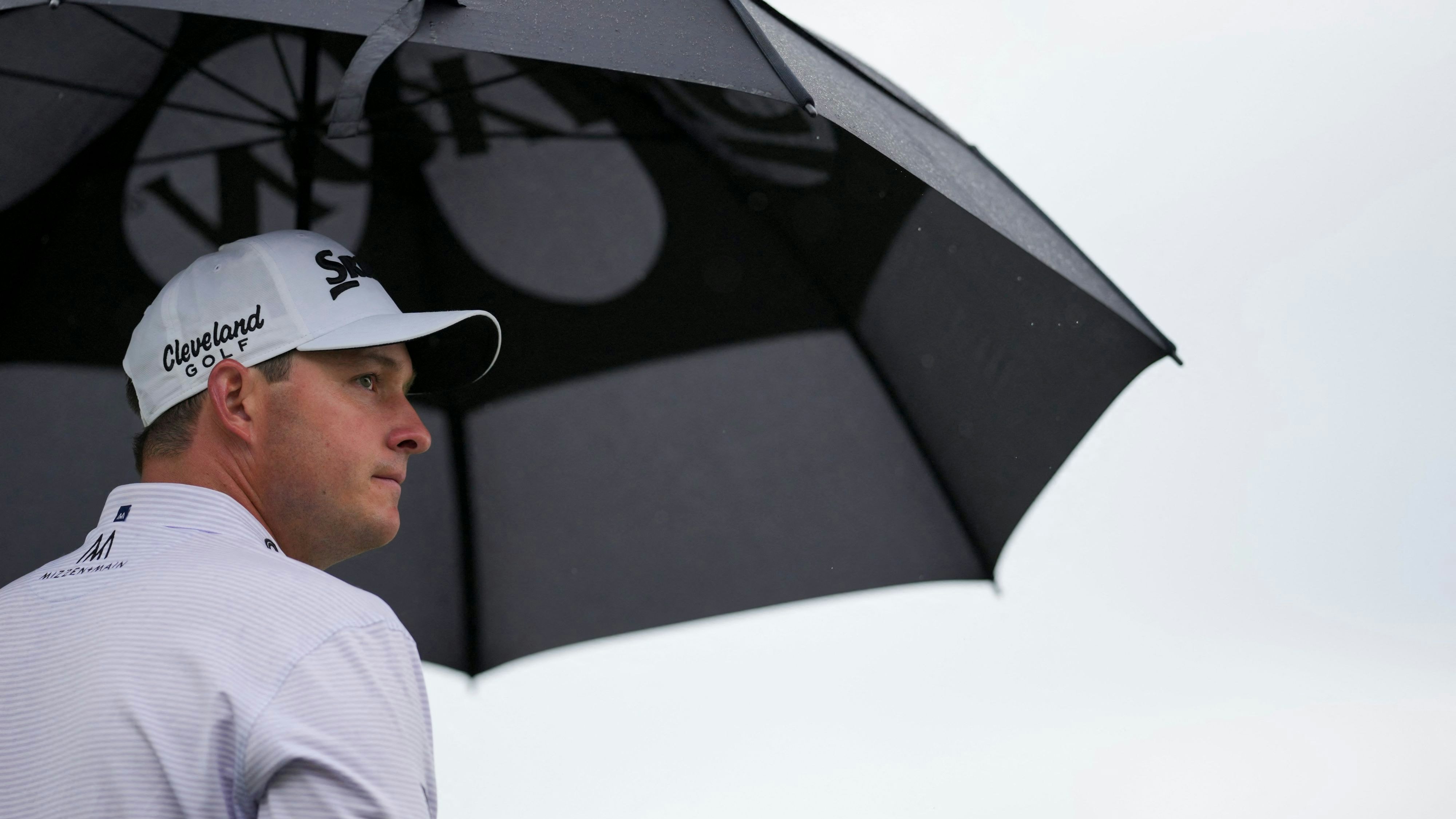 Apr 21, 2024; Hilton Head, South Carolina, USA; Sepp Straka stands under an umbrella as rain falls on the first tee during the final round of the RBC Heritage golf tournament. Mandatory Credit: Aaron Doster-USA TODAY Sports