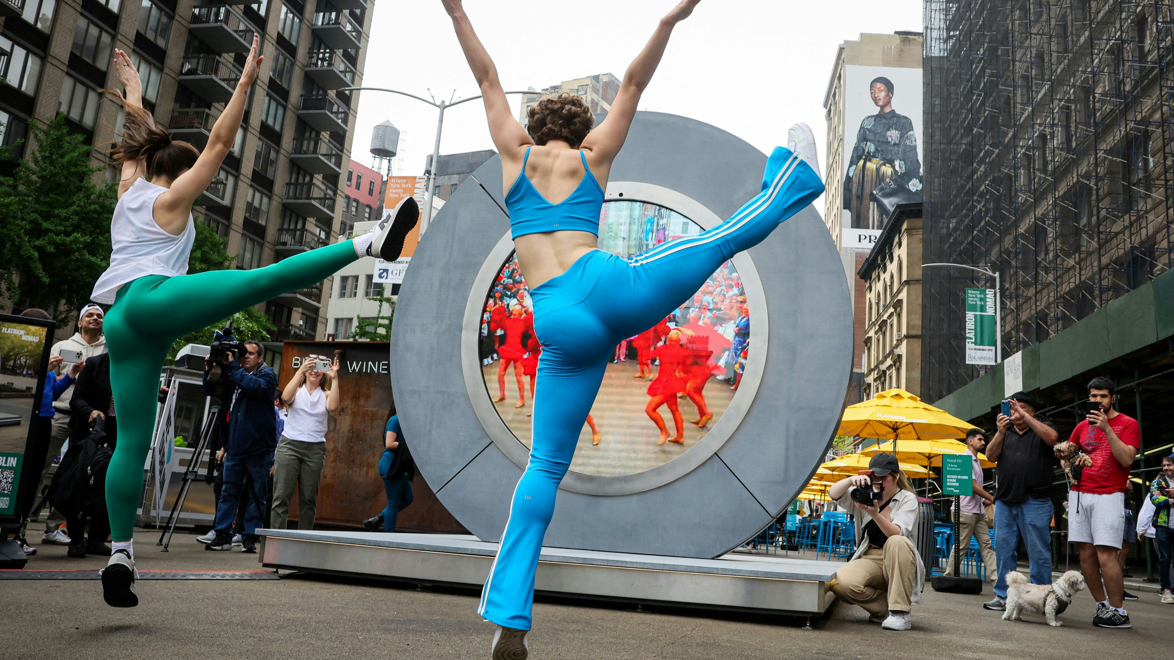 Dancers perform during the reveal of The Portal, a public technology sculpture that links with direct connection between Dublin Ireland and the Flatiron district in Manhattan, in New York City, U.S., May 8, 2024.  REUTERS/Brendan McDermid     