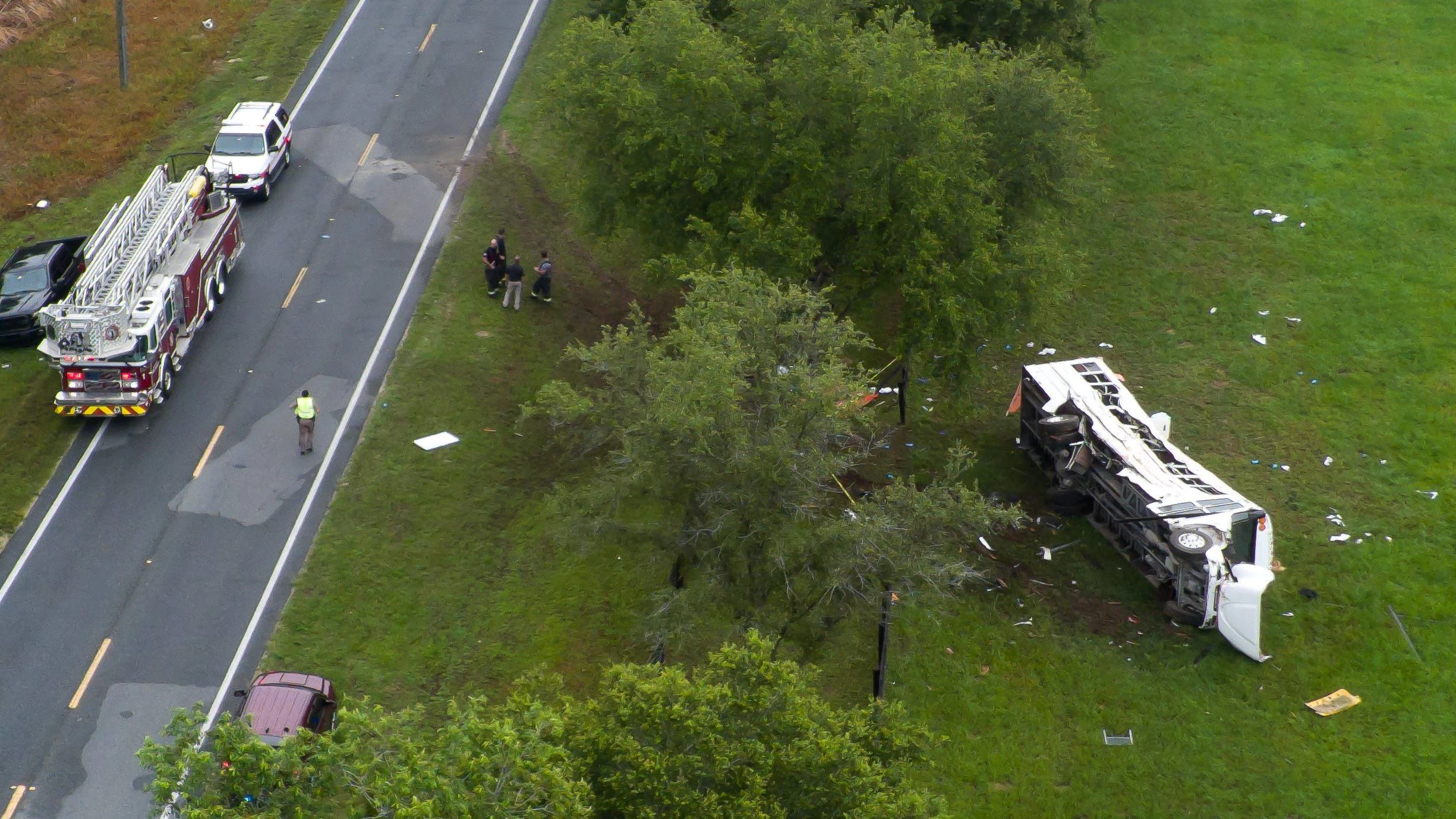 Emergency services attend the scene after a bus carrying laborers to a melon farm overturned in a fatal crash near Dunnellon, Florida, U.S. May 14, 2024. Doug Engle/Ocala Star Banner/USA Today Network via REUTERS.  NO RESALES. NO ARCHIVES. MANDATORY CREDIT