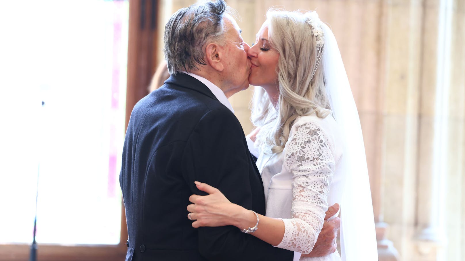 Sie hat "Ja" gesagt! Baumeister Richard Lugner küsst seine Frau Simone Reiländer.
