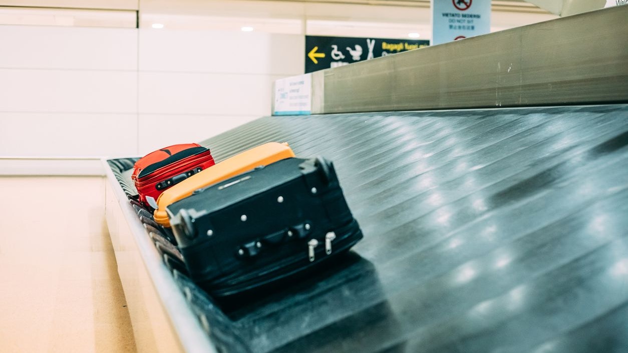 Suitcases on Baggage Claim Conveyor Belt ait Airport.