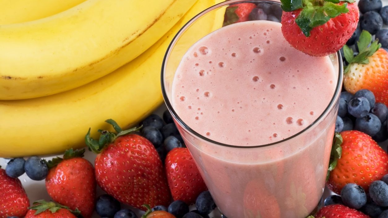 Smoothie surrounded by fruit