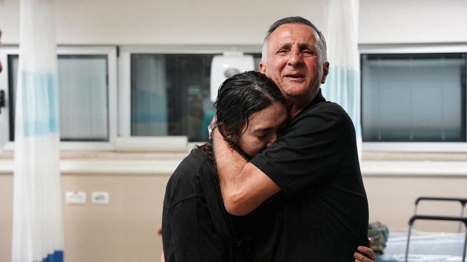 Noa Argamani, a rescued hostage embraces her father, Yakov Argamani, after the military said that Israeli forces have rescued four hostages alive from the central Gaza Strip, in Ramat Gan, Israel, in this handout image obtained by Reuters on June 8, 2024. Israeli Army/Handout via Reuters  THIS IMAGE HAS BEEN SUPPLIED BY A THIRD PARTY