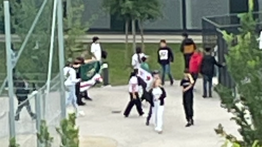 Schüler einer Favoritener Mittelschule mit syrischer und tschetschenischer Flagge im Schulhof.