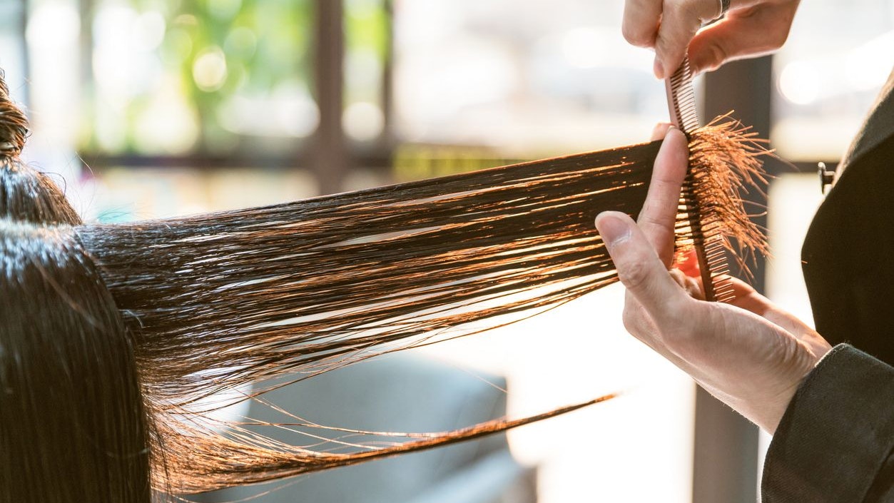 Woman getting her hair styled and hair salon.