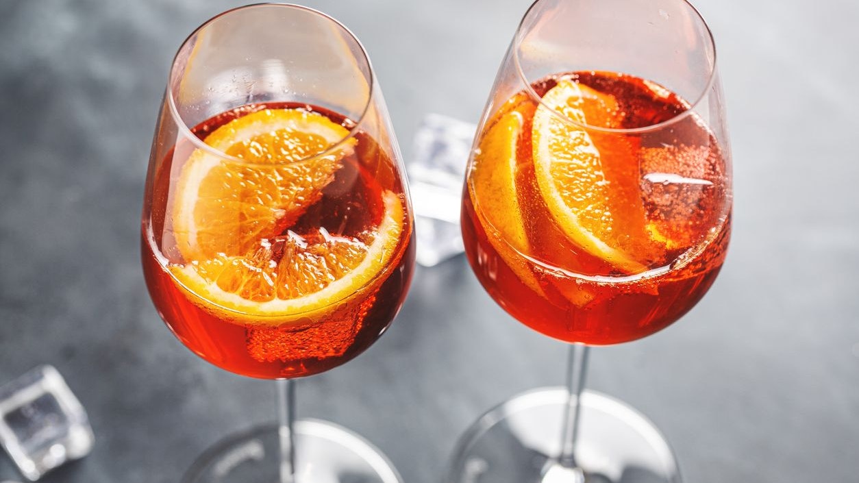 Spritz cocktail with orange slices served in glasses. Closeup