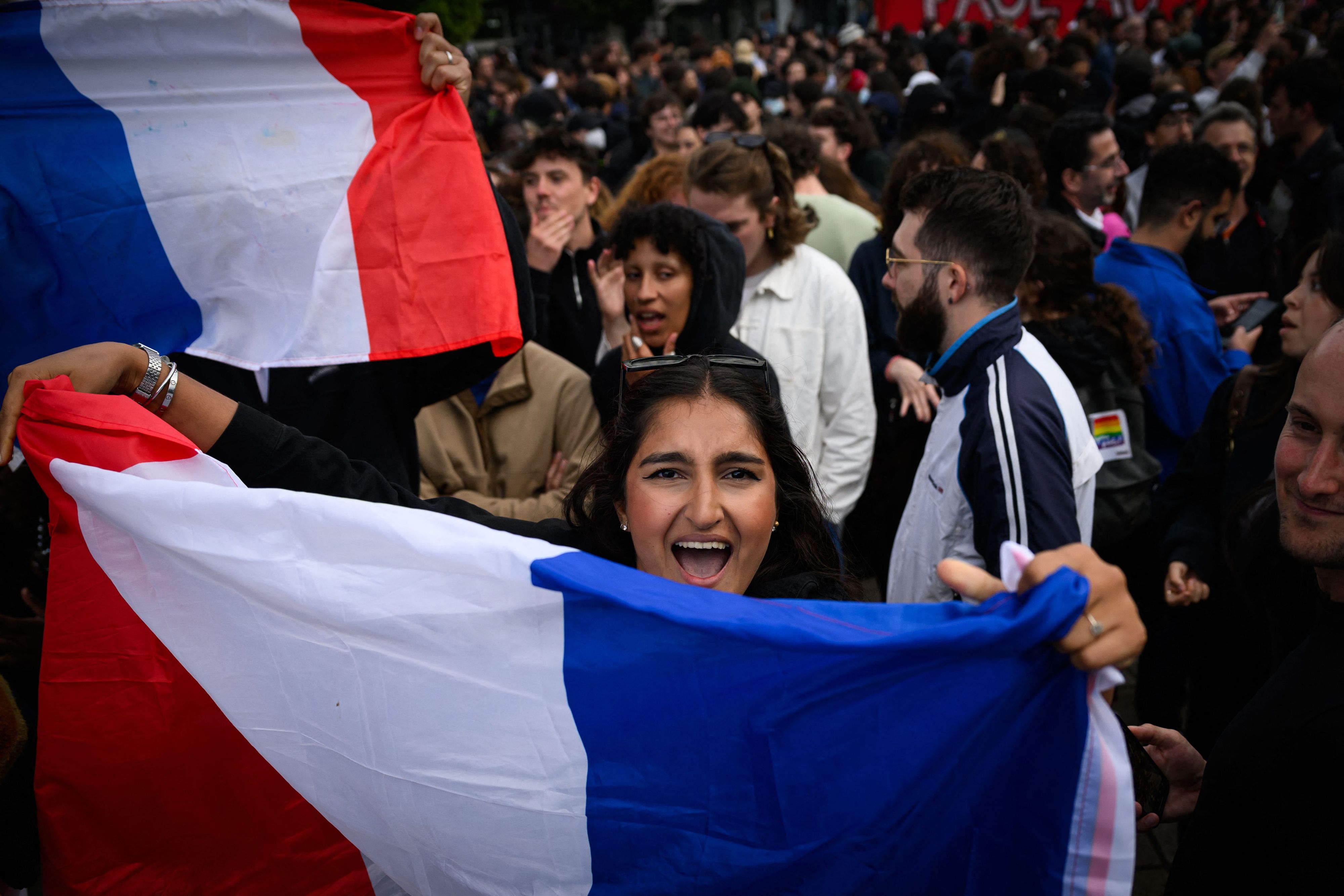 Eine Demonstrantin in Paris freut sich über das Ergebnis der Frankreich-Wahl.