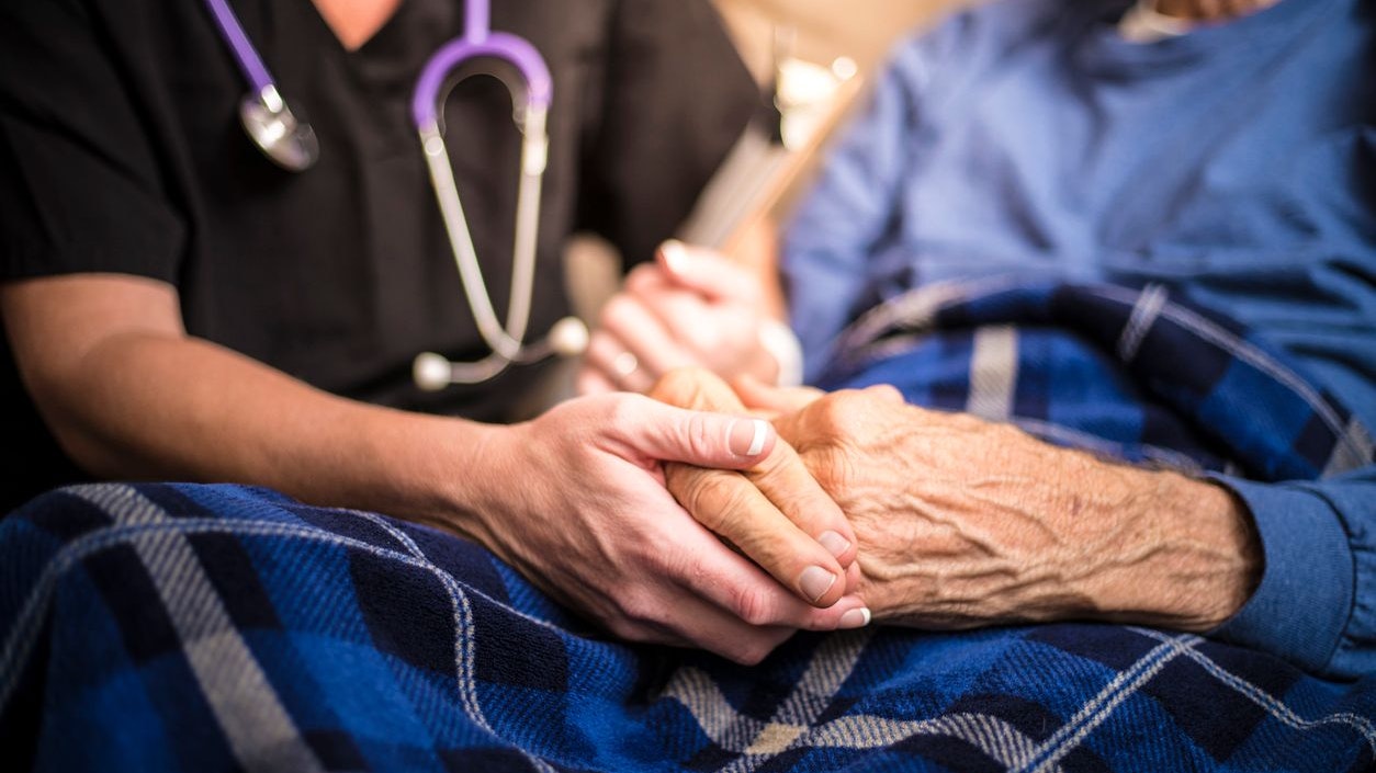 A stock photo of a Hospice Nurse visiting an Elderly male patient who is receiving hospice/palliative care.