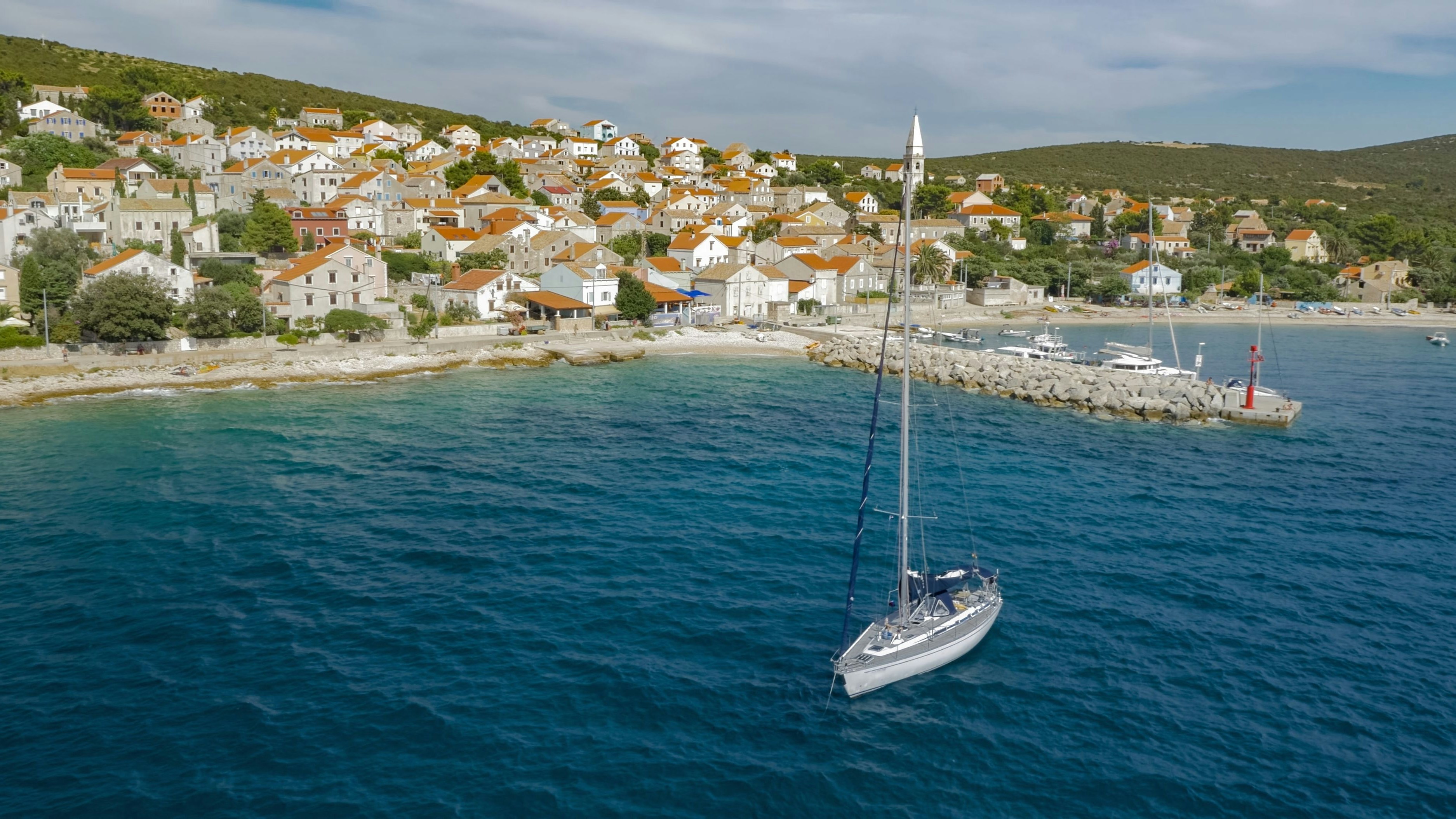 View of townscape, boats moored in sea in foreground.