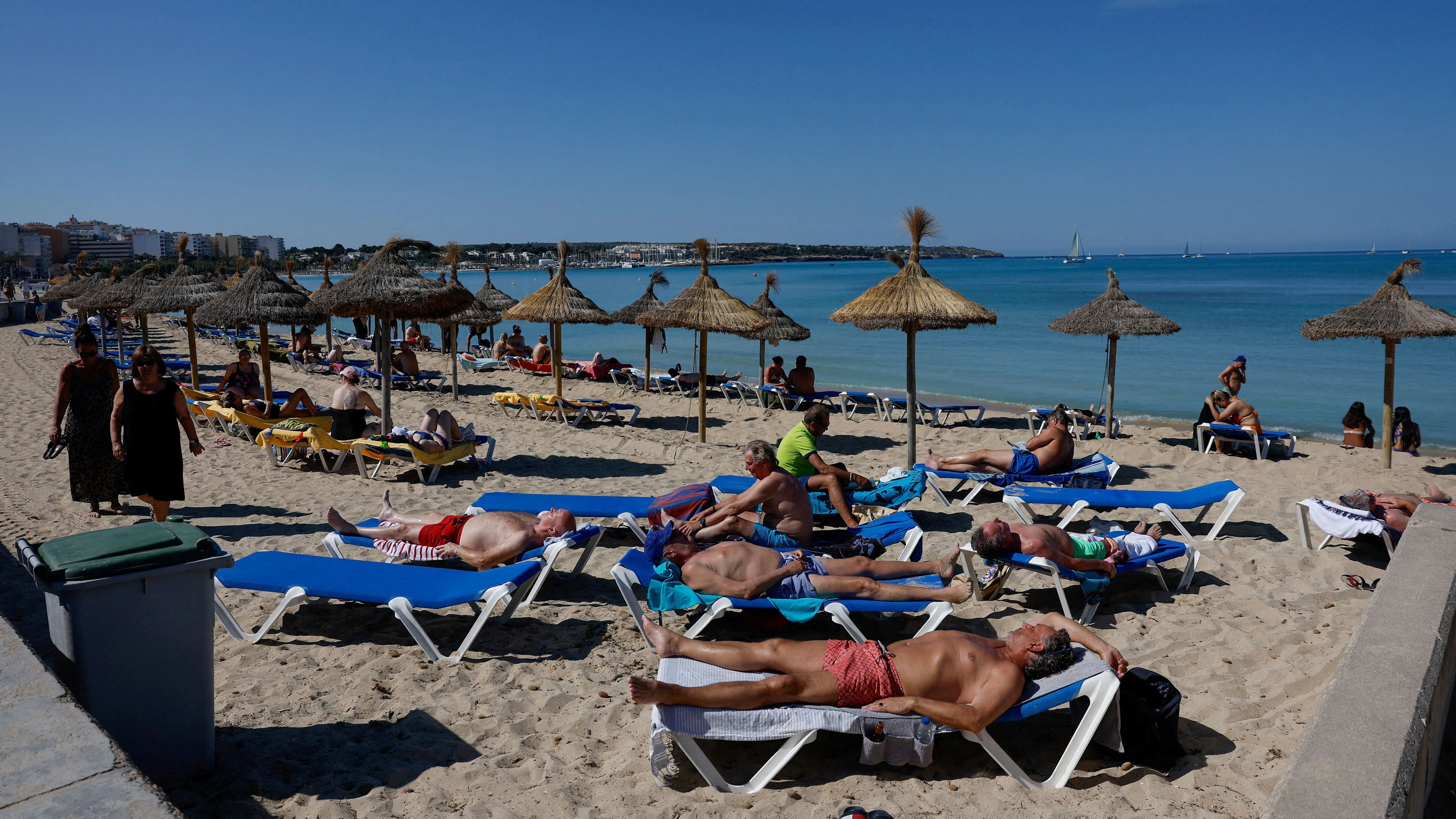 FILE PHOTO: Tourists sunbathe in El Arenal beach in Palma de Mallorca, Spain, May 25, 2024. 