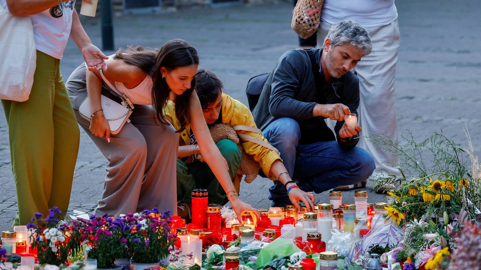 Knapp eine Woche nach der Messerattacke in Solingen entzünden Menschen Kerzen am Tatort.