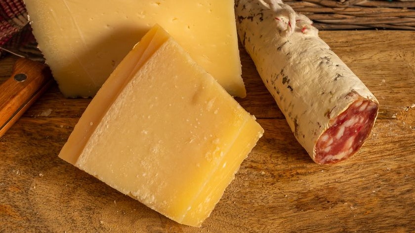 Cheese board and Iberian sausage on slate stone