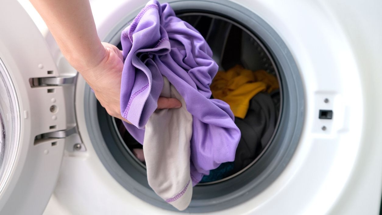 Woman's hand Pick up clothes Washing machine.Clean and Healthy Concepts.