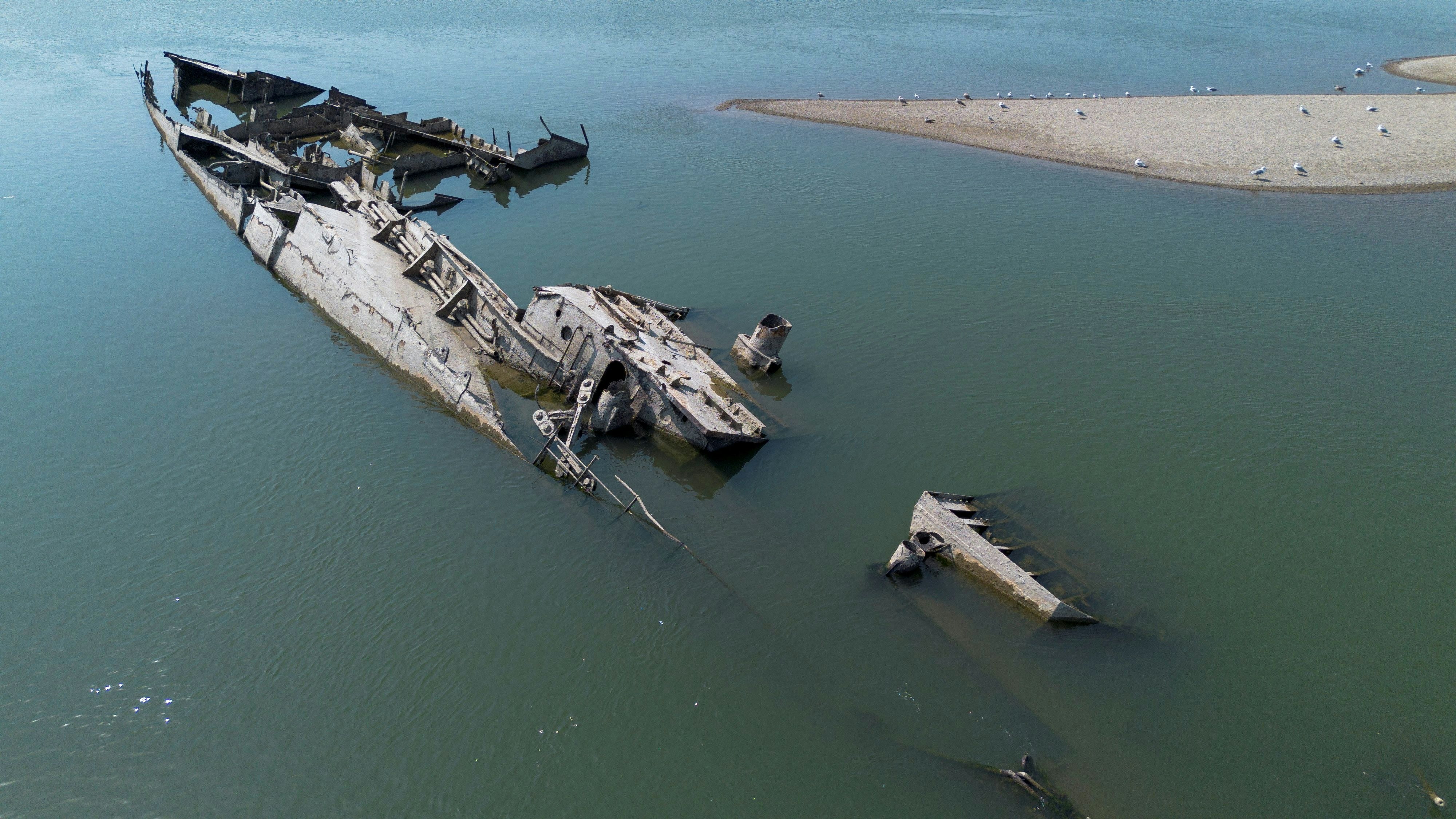 A drone image shows a sunken German warship from World War II, exposed due to low Danube river levels caused by drought and extreme heat, in Prahovo, Serbia, September 5, 2024. REUTERS/Djordje Kojadinovic