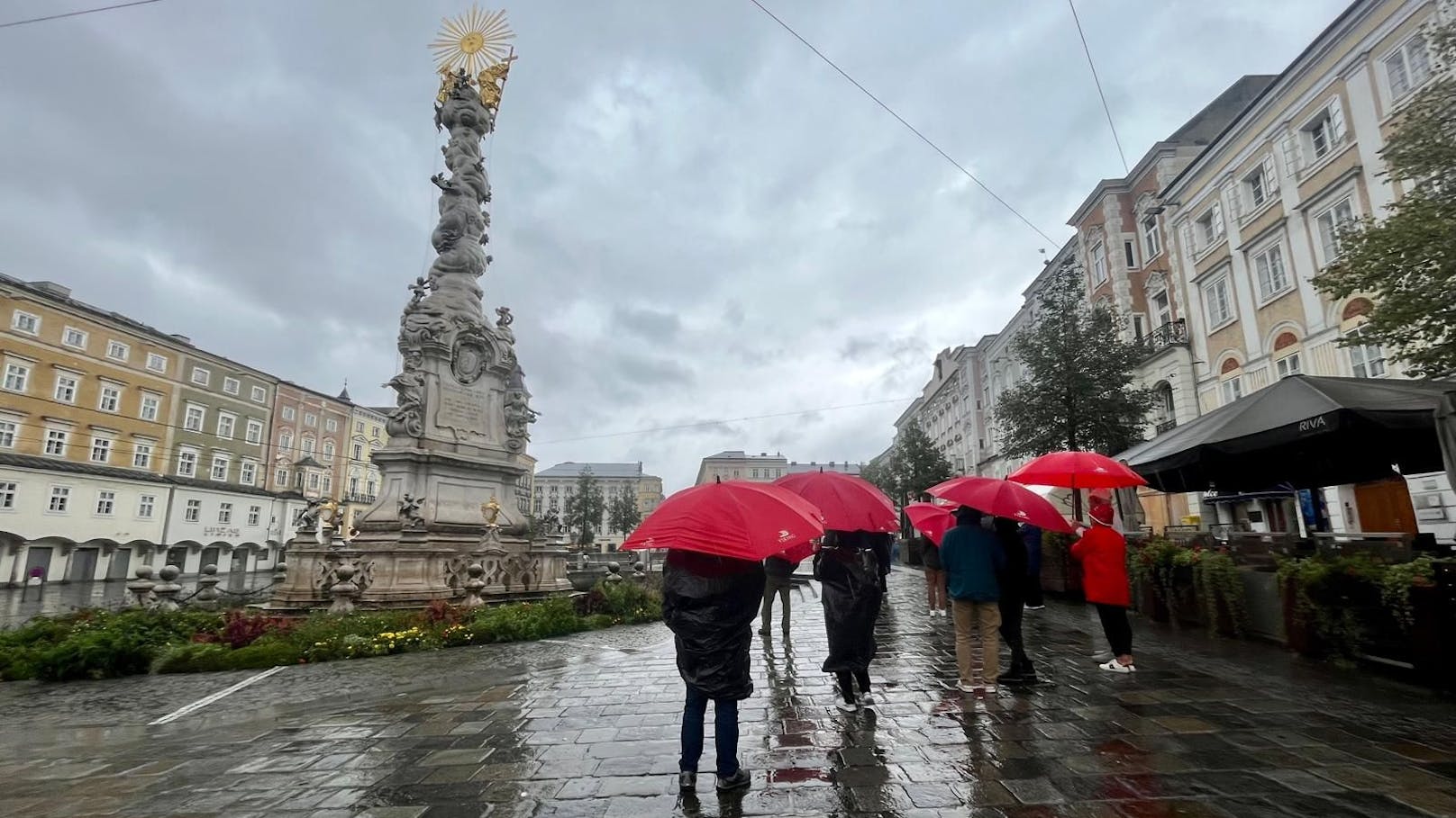 Selbst vom Dauerregen ließ sich eine Touristen-Gruppe in Linz nicht aufhalten.