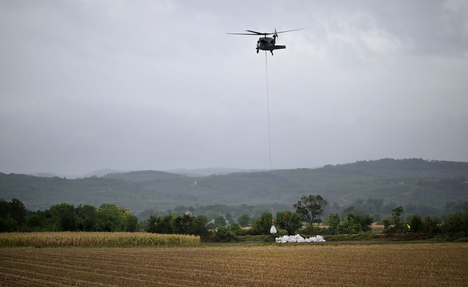 Weiterhin starke Niederschläge und Hochwasser in Niederösterreich. Im Bild: Ein Black Hawk Hubschrauber des Bundesheeres bei der Verstärkung eines Dammes in Hadersdorf am Kamp am Montag.