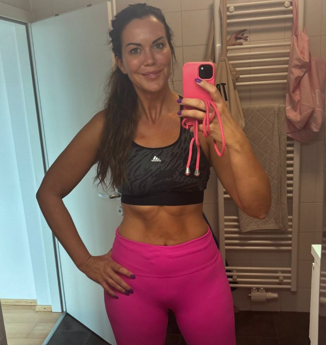 Martina Reuter posiert stolz vor dem Spiegel