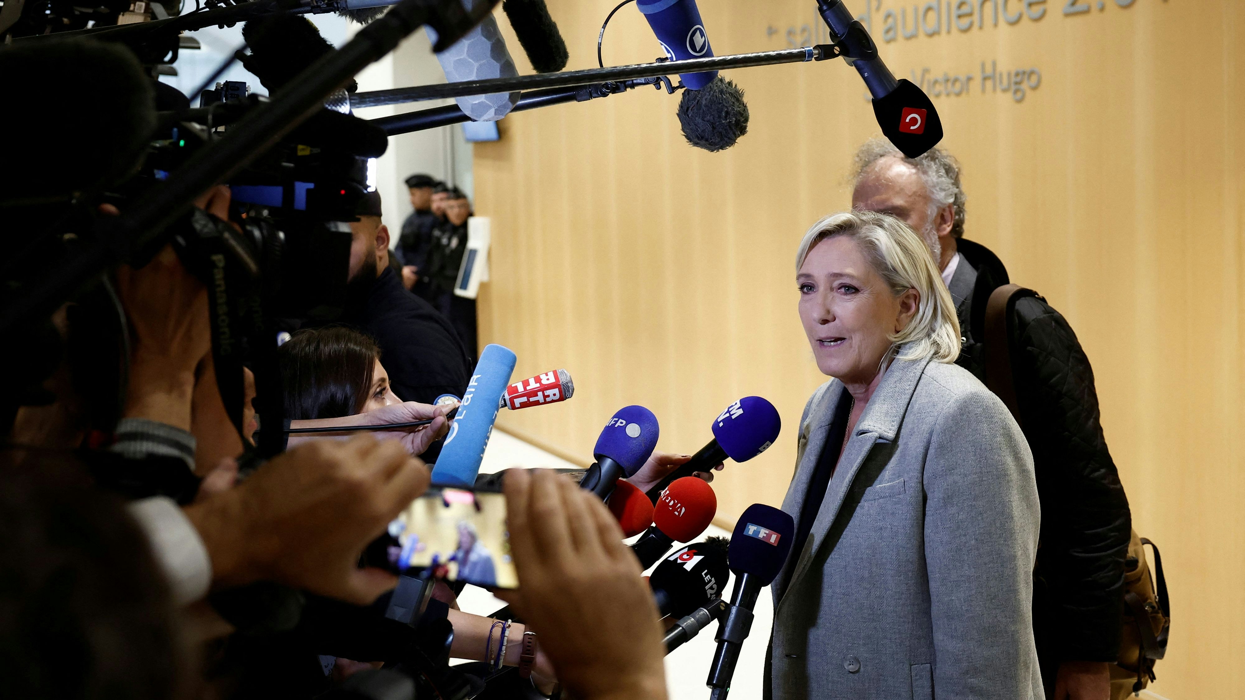 French far-right leader Marine Le Pen, member of parliament of the Rassemblement National (National Rally - RN) party, talks to journalists as she arrives for her trial alongside 26 other defendants (party officials and employees, former lawmakers and parliamentary assistants) and the RN party itself, over alleged misappropriation of European Union funds, using money intended to pay FN-RN parliamentary assistants for party staff between 2004 and 2016, at the courthouse in Paris, France, September 30, 2024. REUTERS/Benoit Tessier