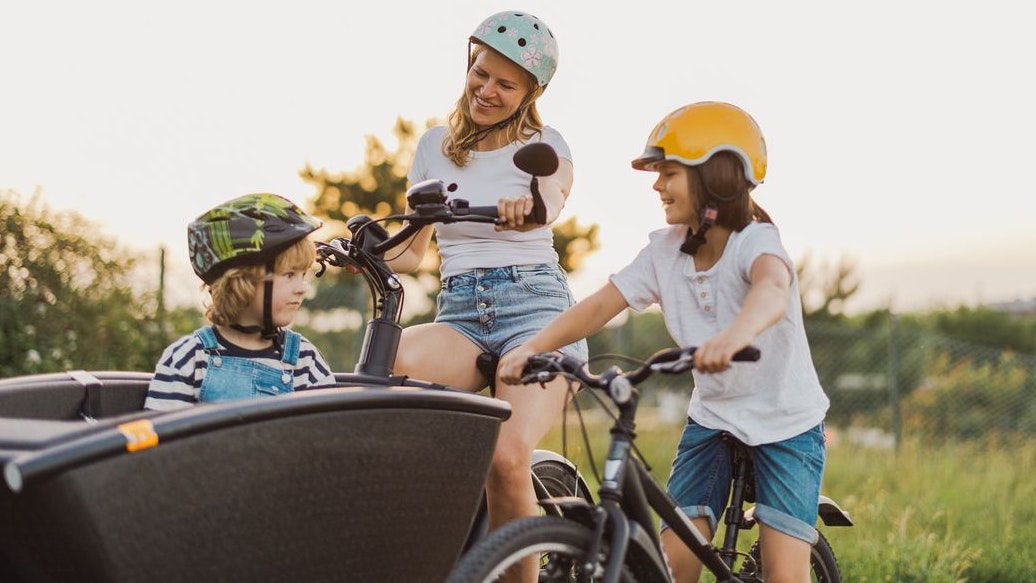 Mother with children cycling in the countryside