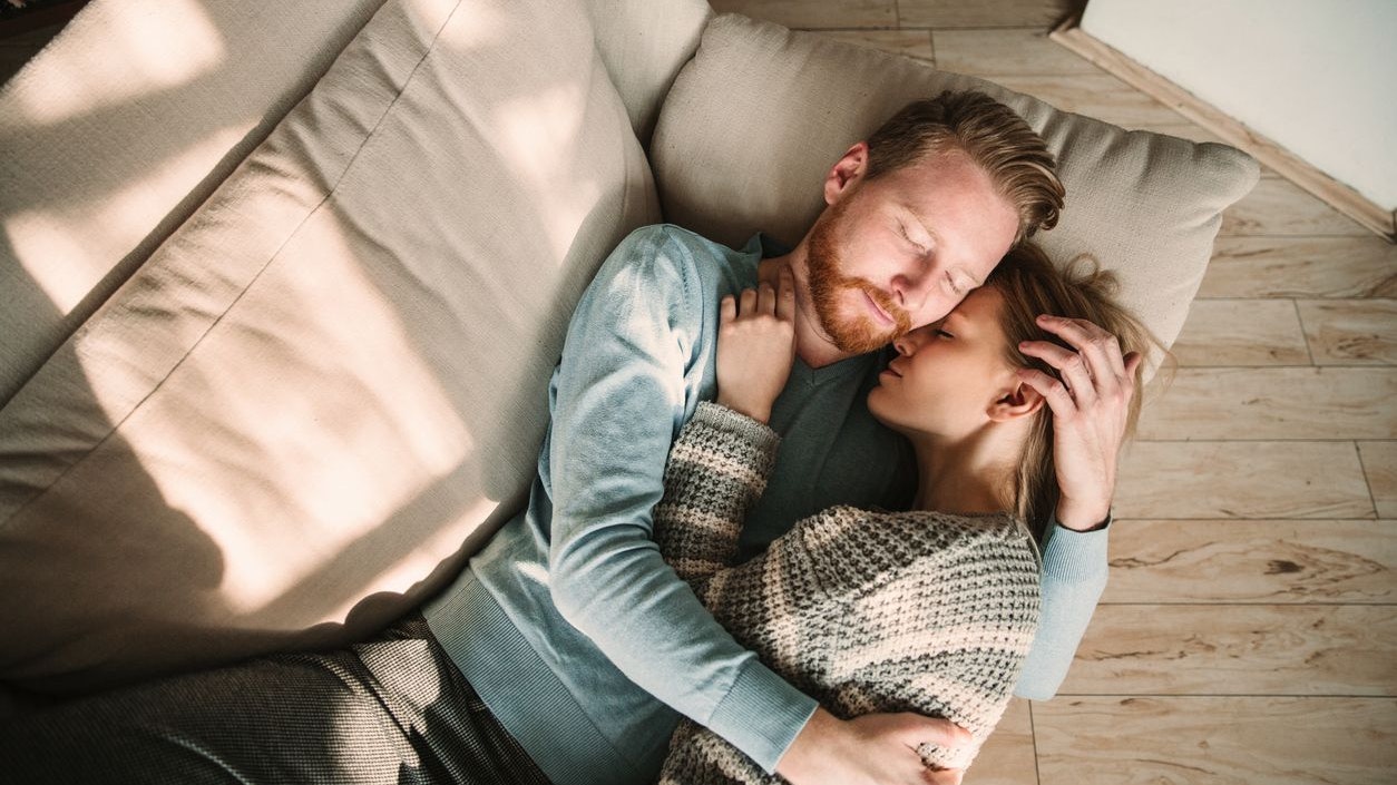 Young couple hugging and embracing each other, close up portrait shot