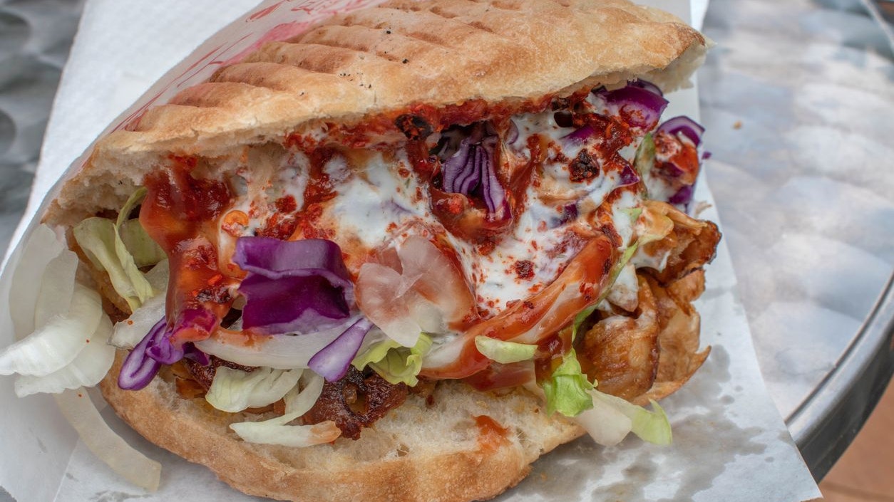 Savor a mouthwatering doner kebab, a popular local street food that will satisfy your cravings.
