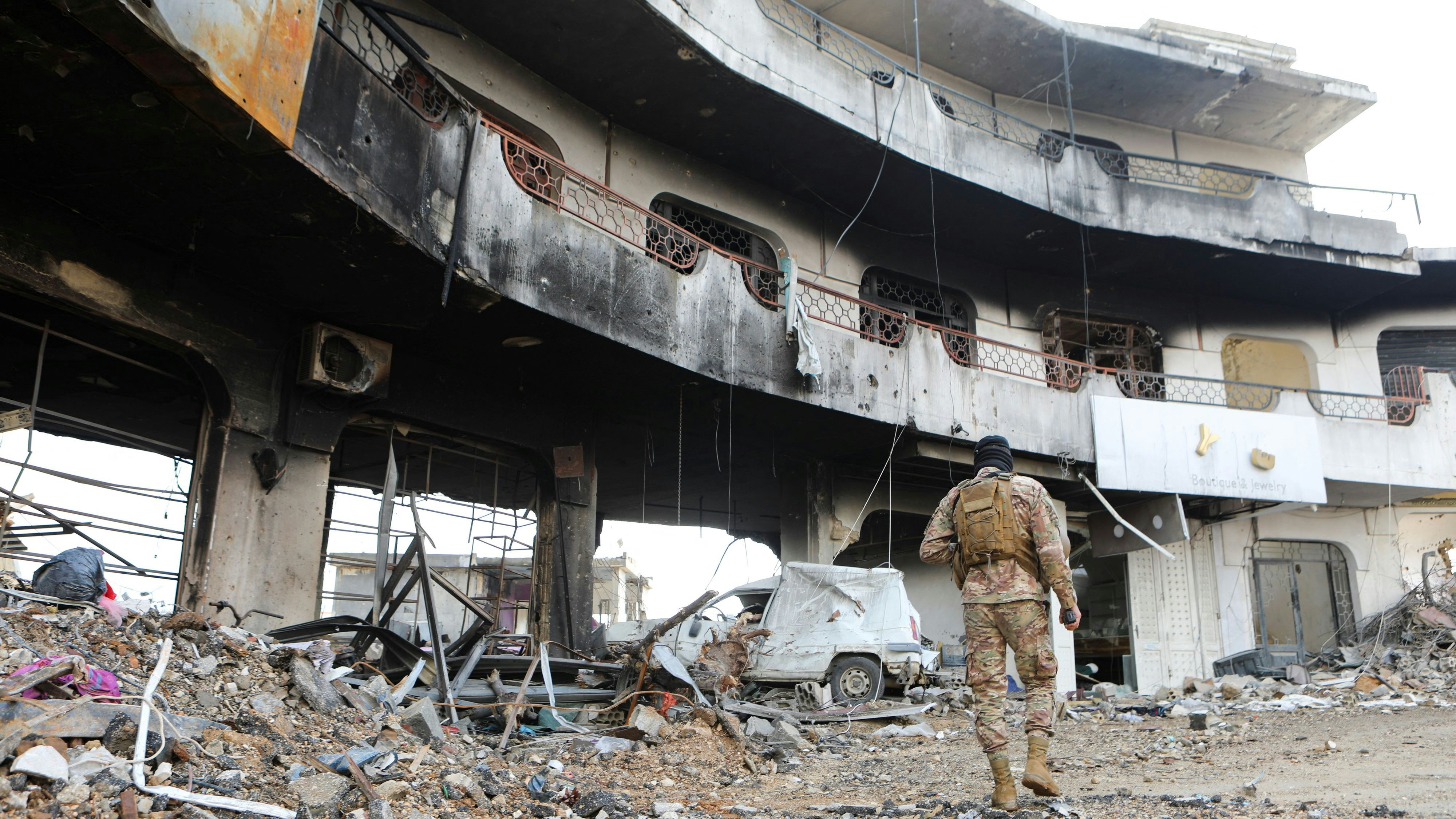 A Lebanese army member walks near rubble at a damaged site after the ceasefire between Israel and Hezbollah, in the Lebanese village of Khiam, December 23, 2024. REUTERS/Karamallah Daher