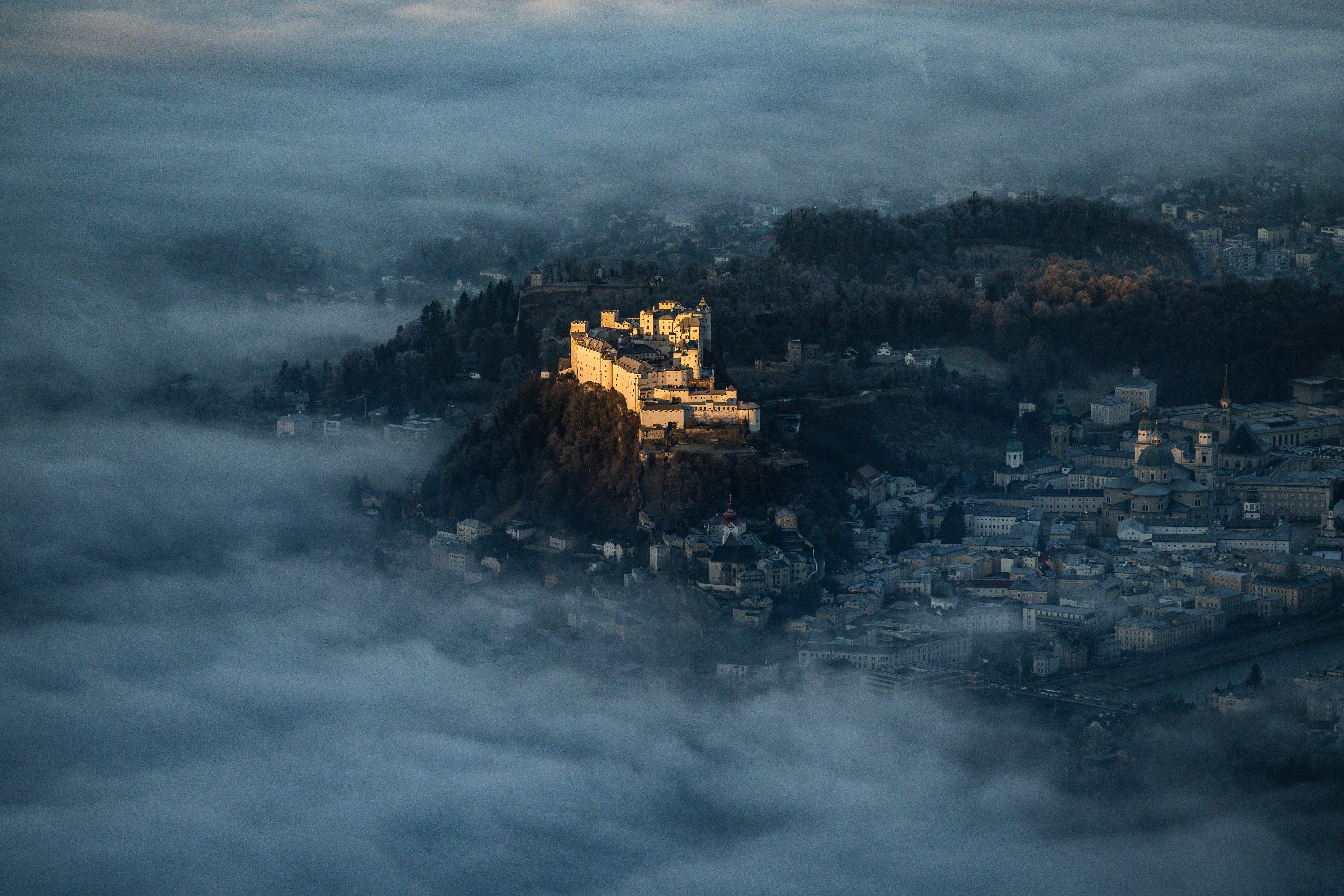 Blick auf die Stadt Salzburg mit der Festung Hohenwerfen zu Sonnenaufgang mit Morgennebel im Winter am 22. Jänner 2025.