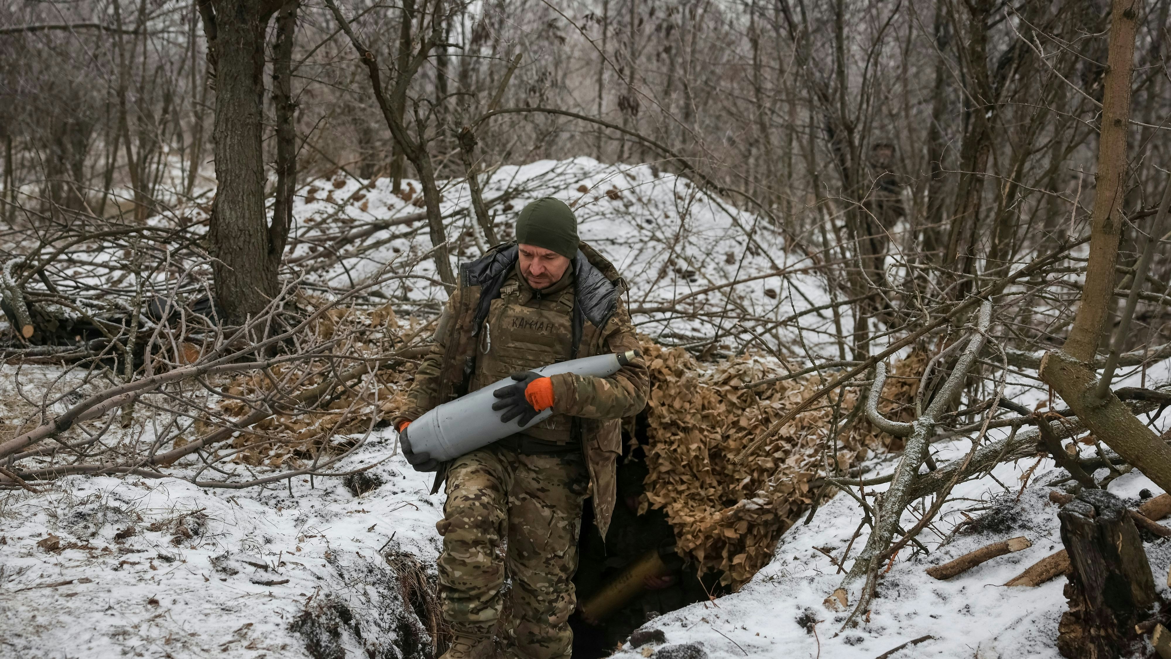 A serviceman of the 32nd Separate Mechanised Brigade of the Armed Forces of Ukraine carries a 152-mm shell to a D-20 howitzer during firing towards Russian troops, amid Russia's attack on Ukraine, near the frontline town of Pokrovsk in Donetsk region, Ukraine February 6, 2025. Radio Free Europe/Radio Liberty/Serhii Nuzhnenko via REUTERS 