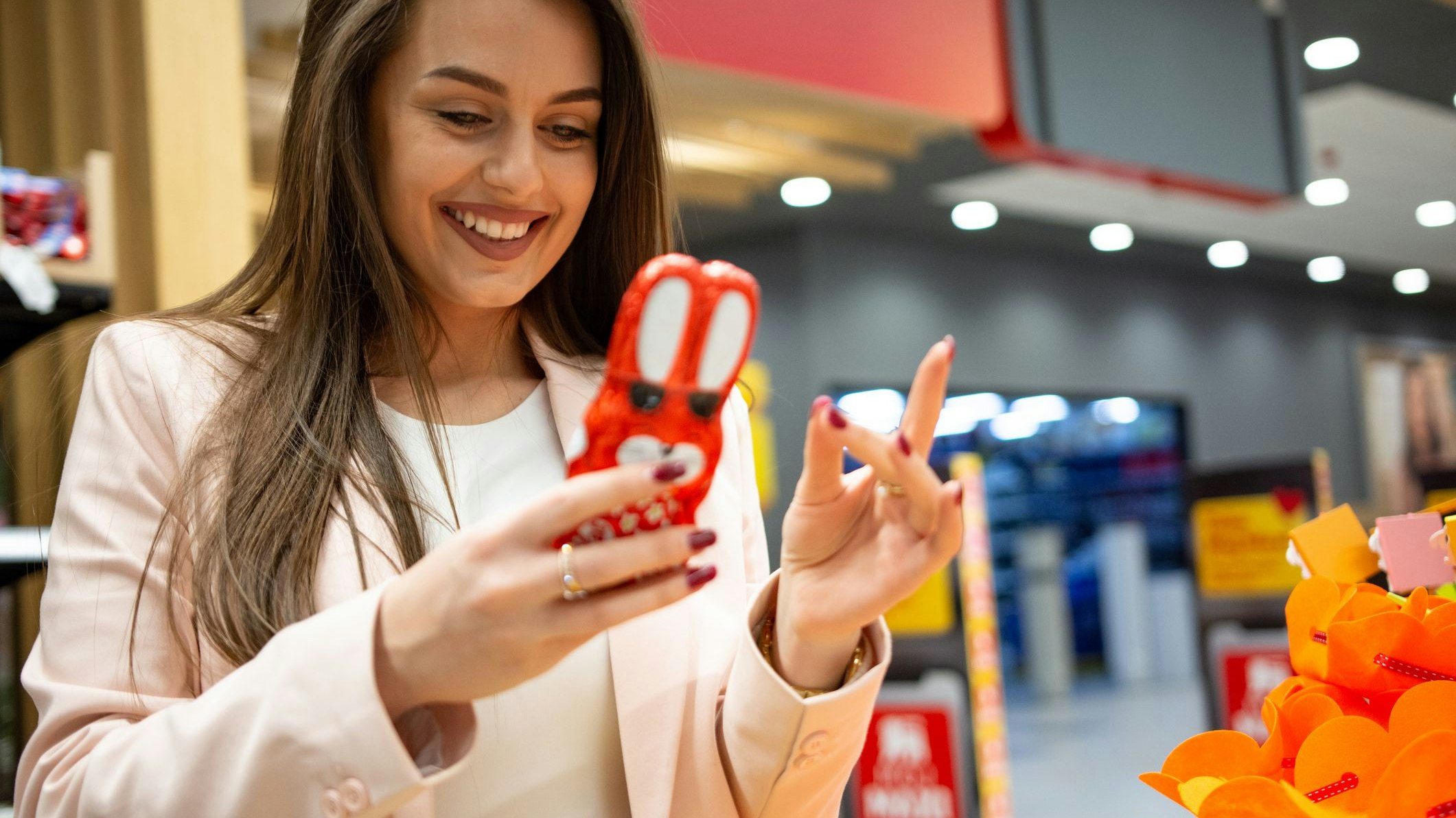 Young woman enjoying while buying in supermarket