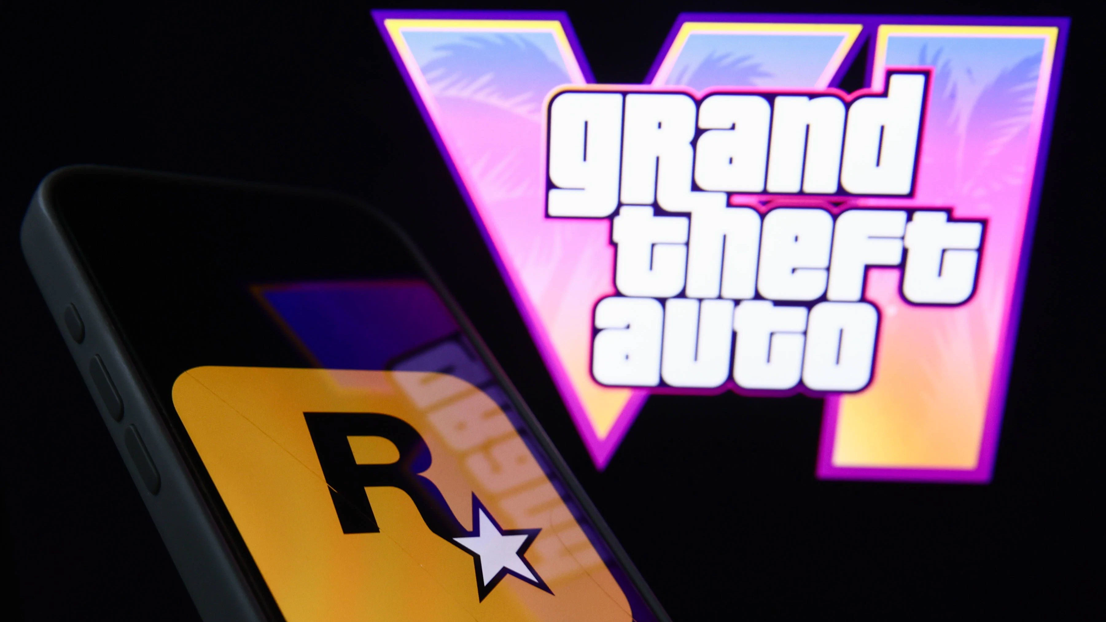 GTA VI Photo Illustrations GTA VI logo from the trailer displayed on a laptop screen and Rockstar Games logo displayed on a phone screen are seen in this illustration photo taken in Krakow, Poland on December 5, 2023. Krakow Poland PUBLICATIONxNOTxINxFRA Copyright: xJakubxPorzyckix originalFilename: porzycki-gtavipho231205_npGXH.jpg
