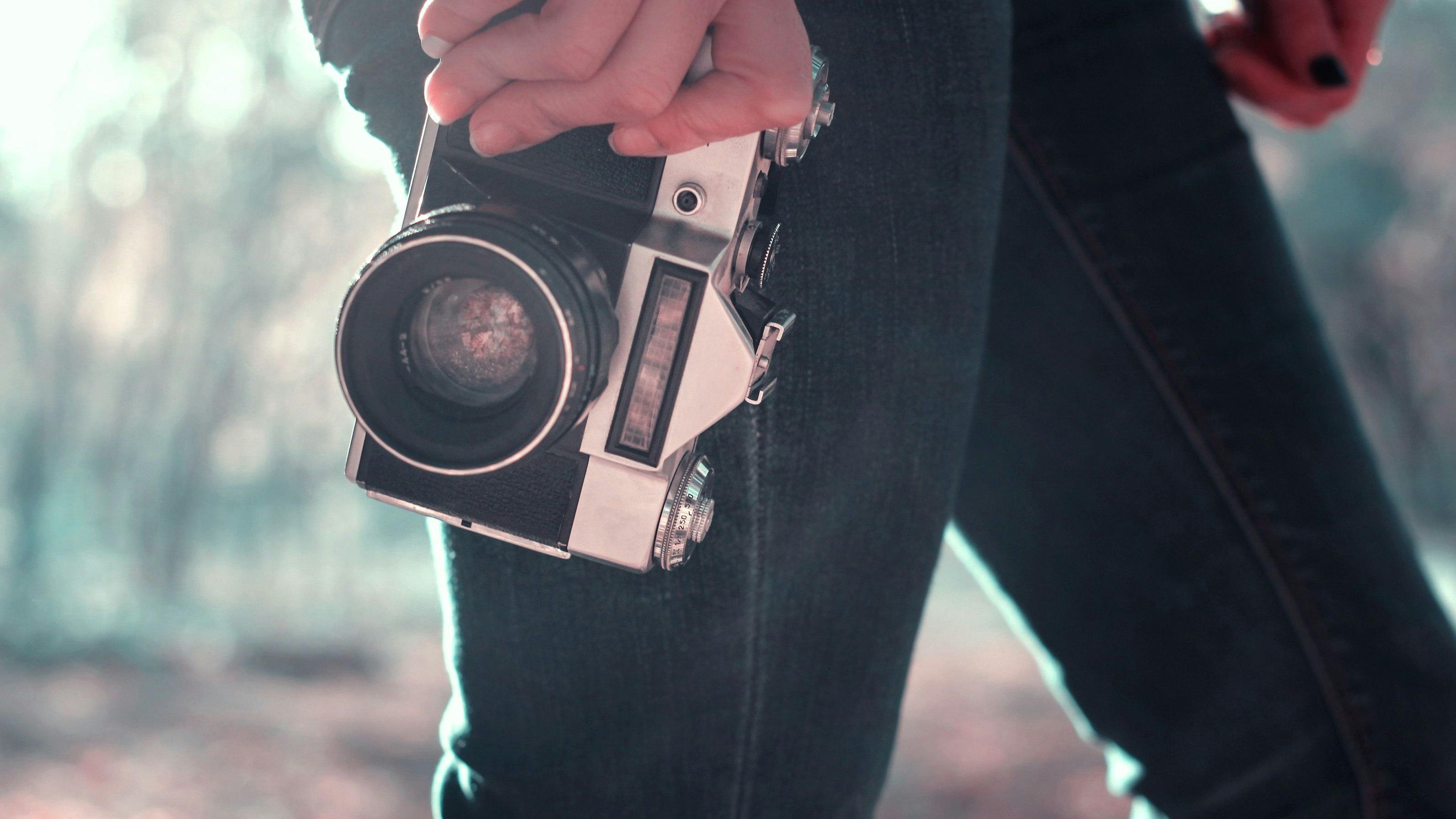 Vintage camera in hand of young photographer and ready to take photo