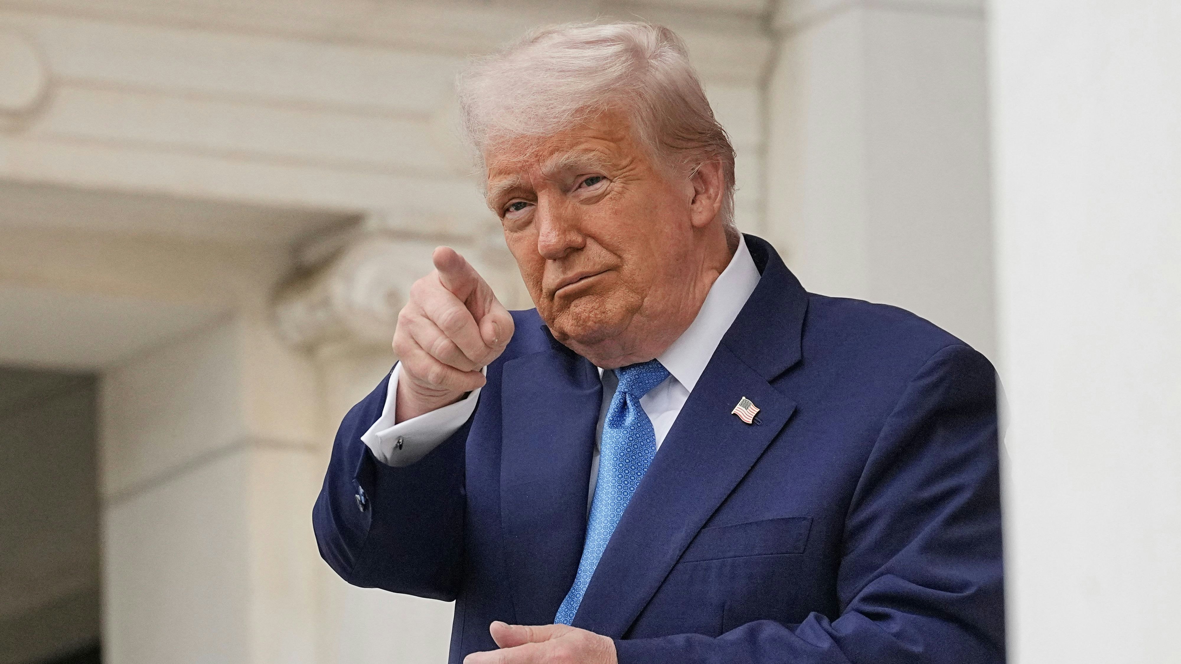 U.S. President Donald Trump gestures at the annual National Memorial Day Observance in the Memorial Amphitheater, at Arlington National Cemetery in Arlington, Virginia, U.S., May 26, 2025. REUTERS/Ken Cedeno