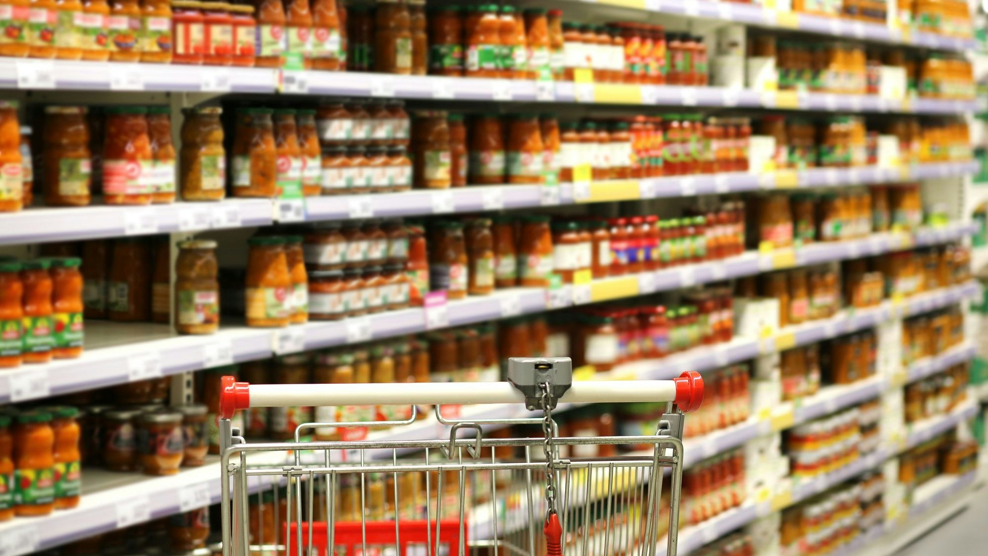 empty grocery cart in an empty supermarket