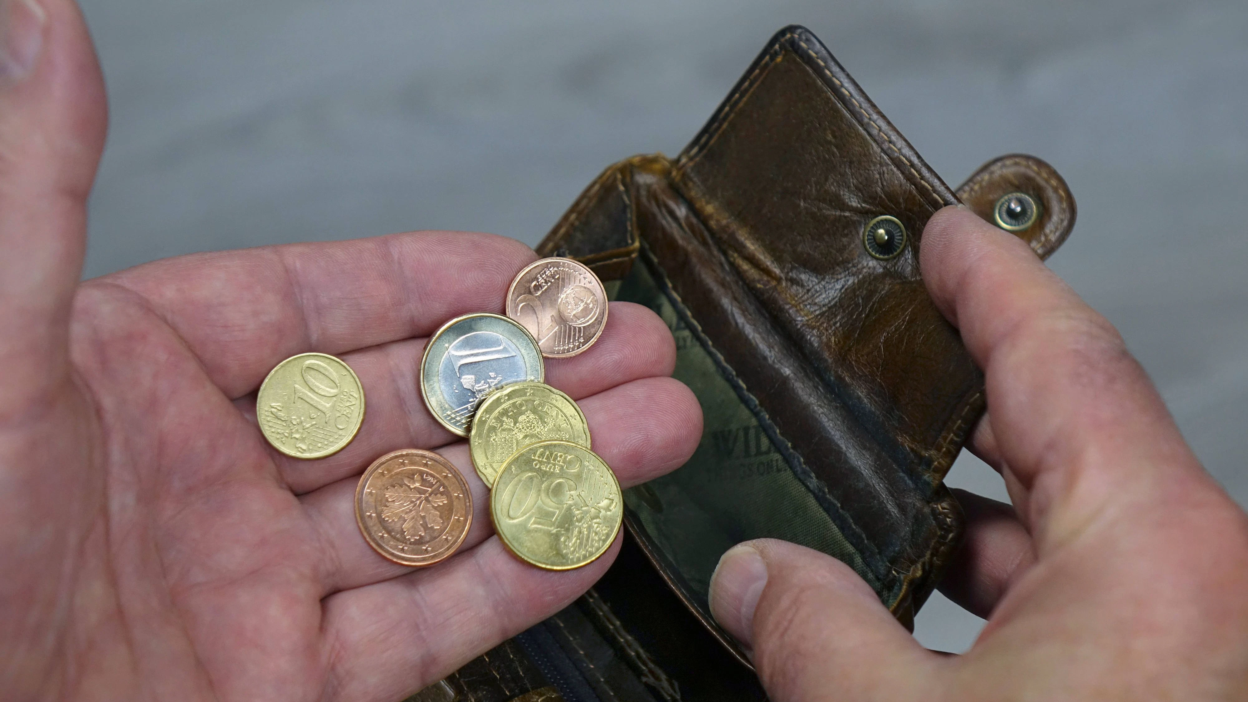 Hand mit Portemonnaie und Kleingeld Hand mit Portemonnaie und Kleingeld, 09.07.2023, Borkwalde, Brandenburg, Eine Hand mit einem Portemonnaie hält verschiedene Münzen. *** Hand with wallet and small change Hand with wallet and small change, 09 07 2023, Borkwalde, Brandenburg, A hand with a wallet holds various coins