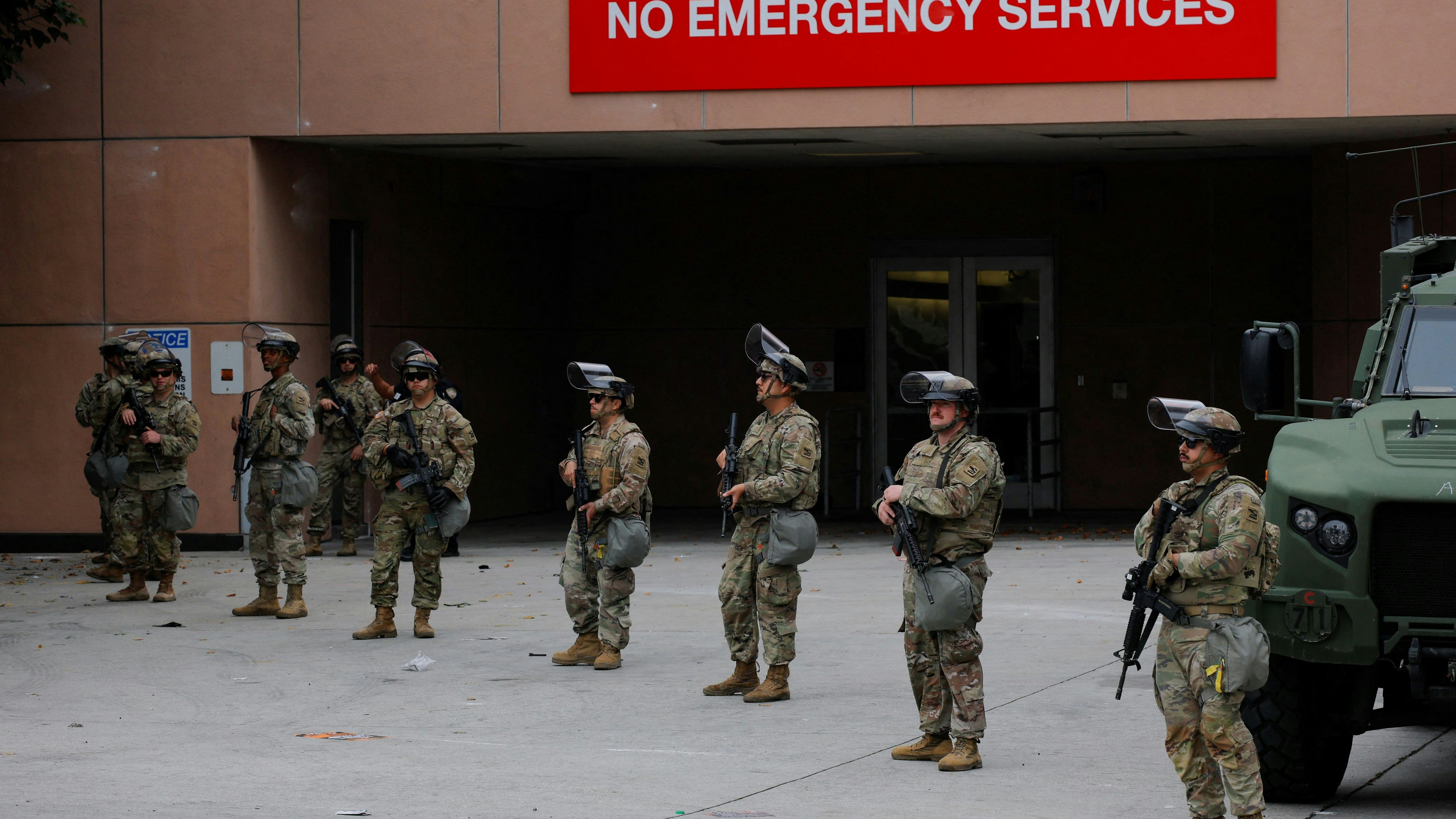 Members of the California National Guard stand outside the Edward R. Roybal federal building after their deployment by U.S. President Donald Trump, in response to protests against immigration sweeps, in Los Angeles, California, U.S. June 8, 2025.  REUTERS/Mike Blake