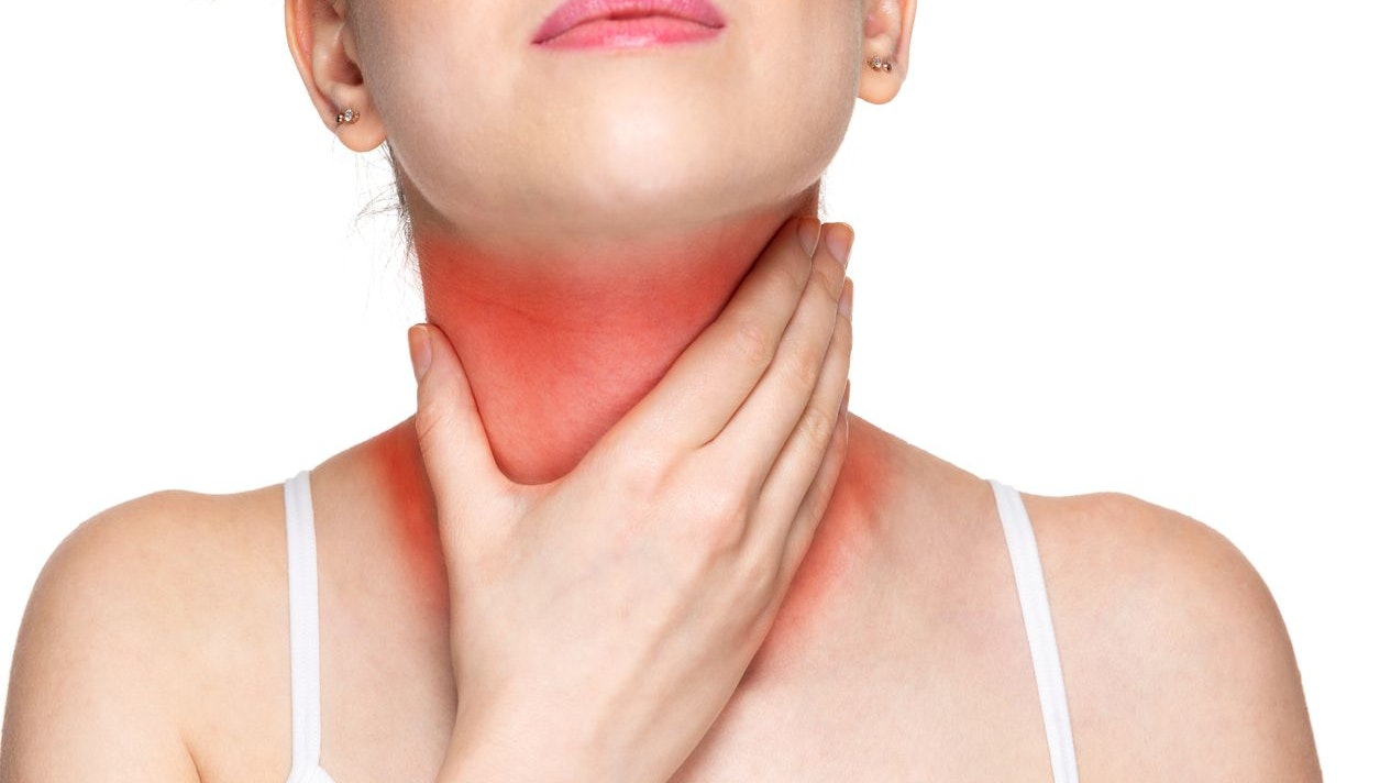Woman with throat ache touching her throat isolated on white background