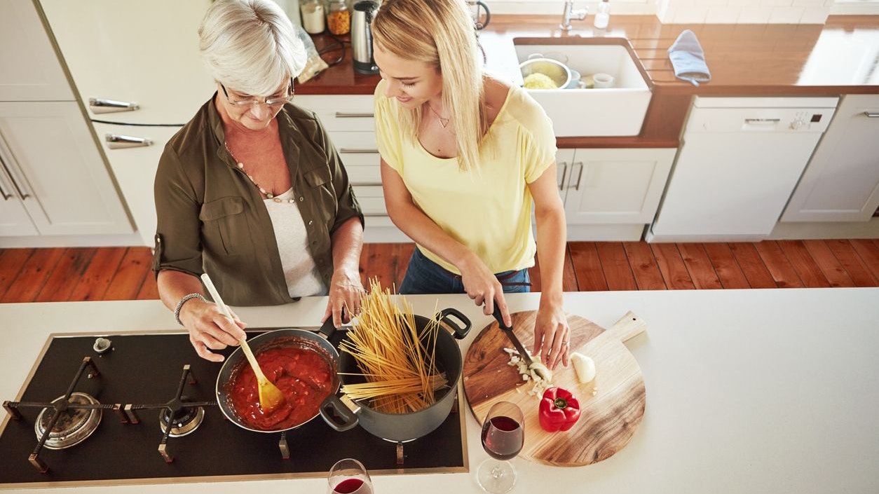 Shot of a senior woman and her daughter cooking in the kitchen