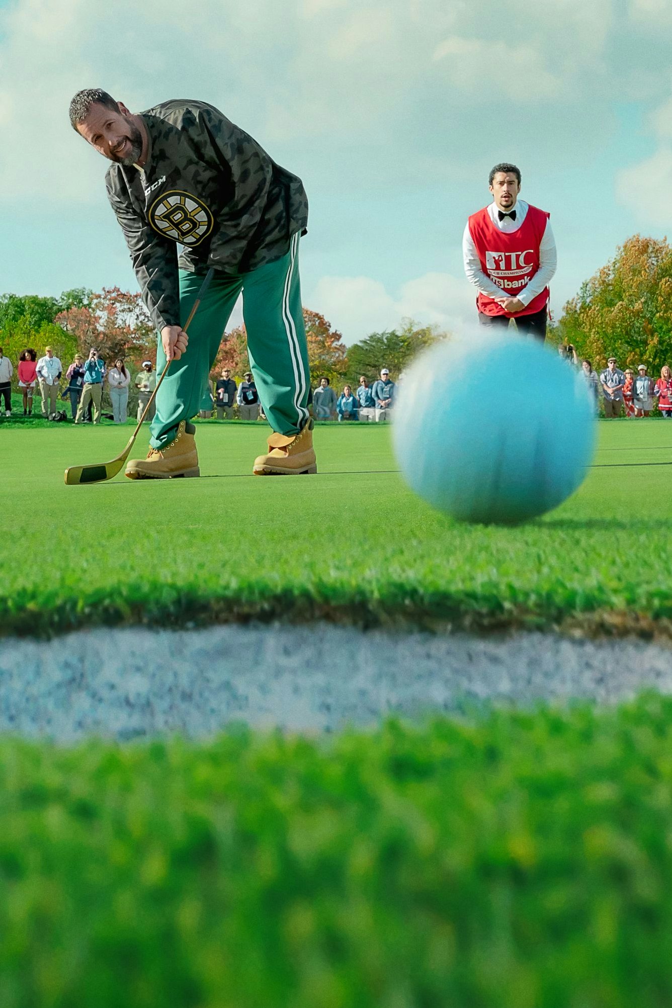 Happy Gilmore 2. Adam Sandler as Happy Gilmore and Benito Antonio Martínez Ocasio as Oscar Mejias in Happy Gilmore 2. Cr. Scott Yamano/Netflix © 2025.