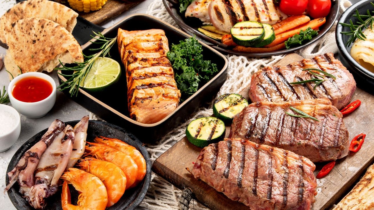 Grilled fish, seafood and meat assortment. Homemade healthy food concept.