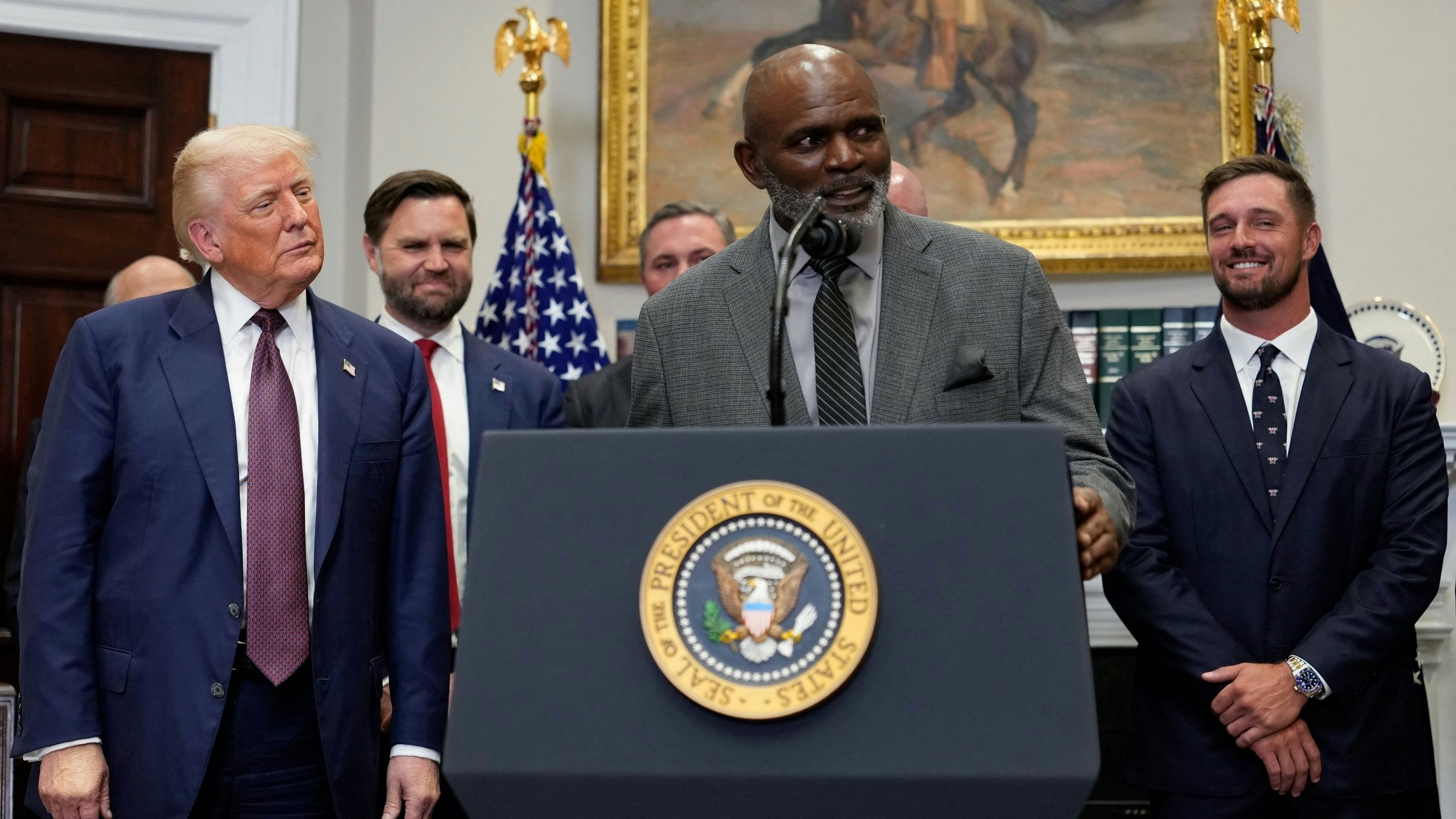 Former professional football player Lawrence Taylor speaks next to U.S. President Donald Trump, in the Roosevelt Room at the White House in Washington, D.C., U.S., July 31, 2025. REUTERS/Kent Nishimura