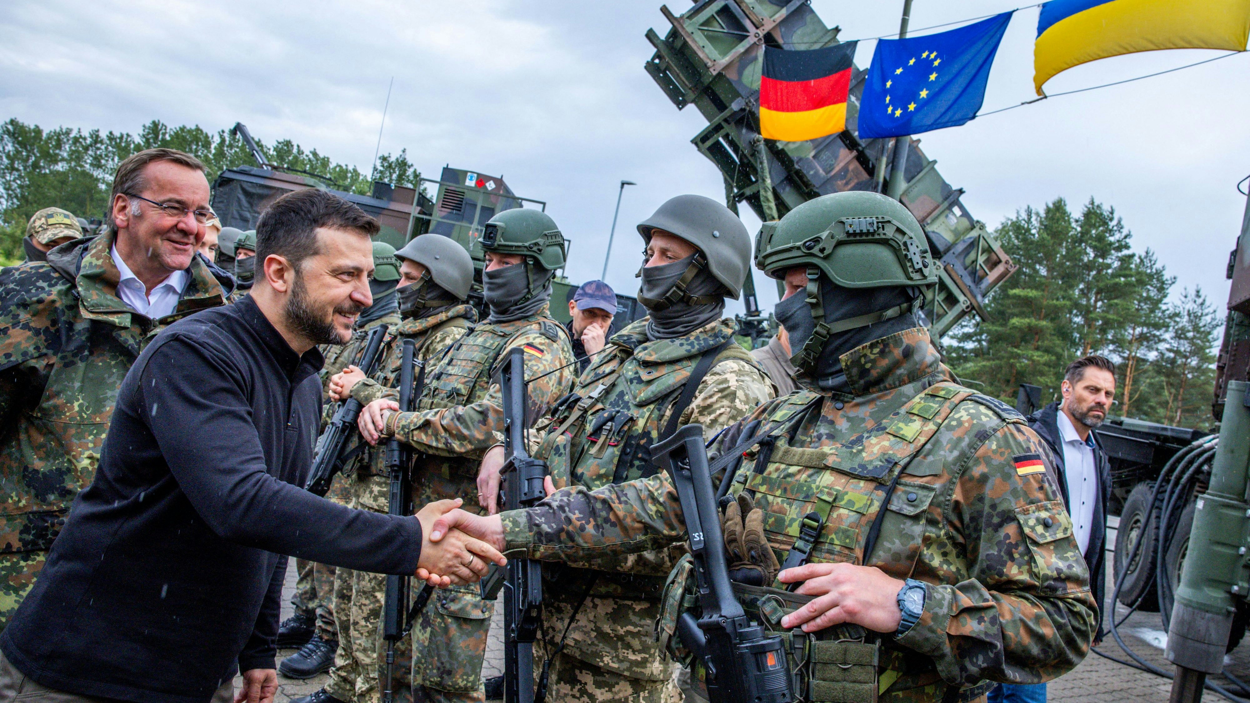 Ukrainian President Volodymyr Zelenskiy interacts with soldiers during his visit to a military training area to find out about the training of Ukrainian soldiers on the “Patriot” anti-aircraft missile system, at an undisclosed location, in Germany, June 11, 2024.   Jens Buttner/Pool via REUTERS