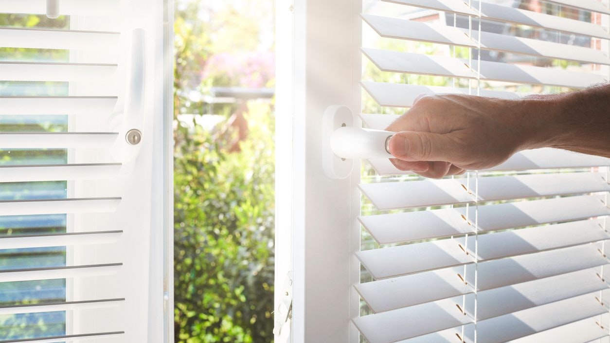 Opening a modern window with blinds